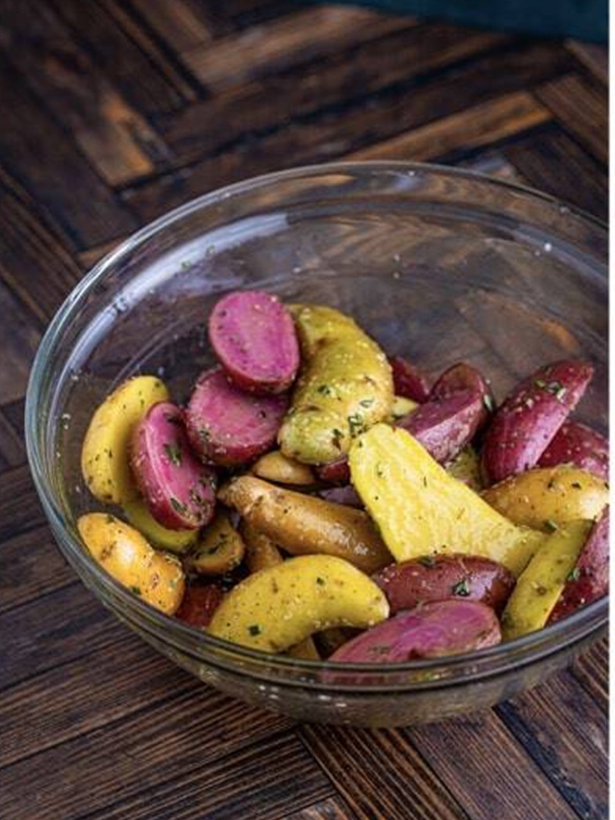 Fingerling potatoes tossed until evenly coated in oil and seasonings.