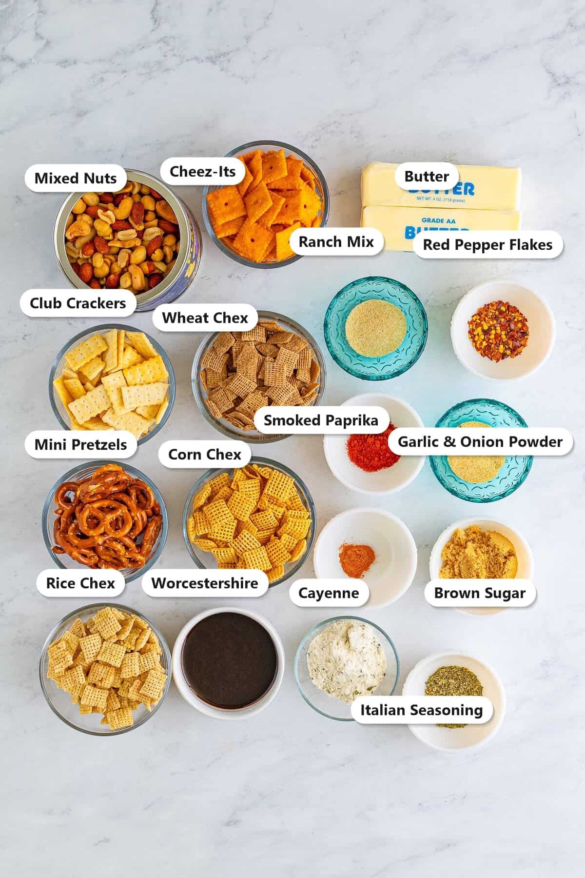 Firecracker chex mix ingredients labeled including corn, wheat, and rice chex, cheez-its, mini pretzels, club crackers, mixed nuts, butter, worcestershire, ranch mix, brown sugar, and spices.
