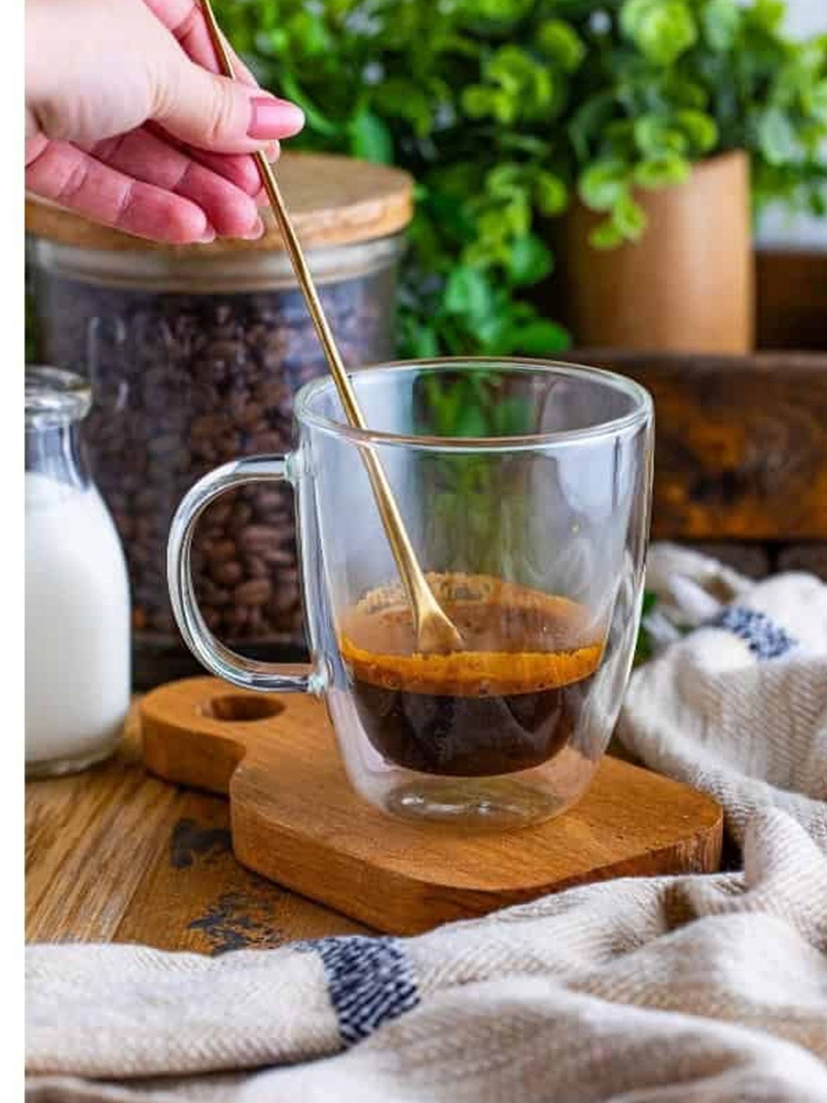 Stirring espresso powder and water into a shot of espresso