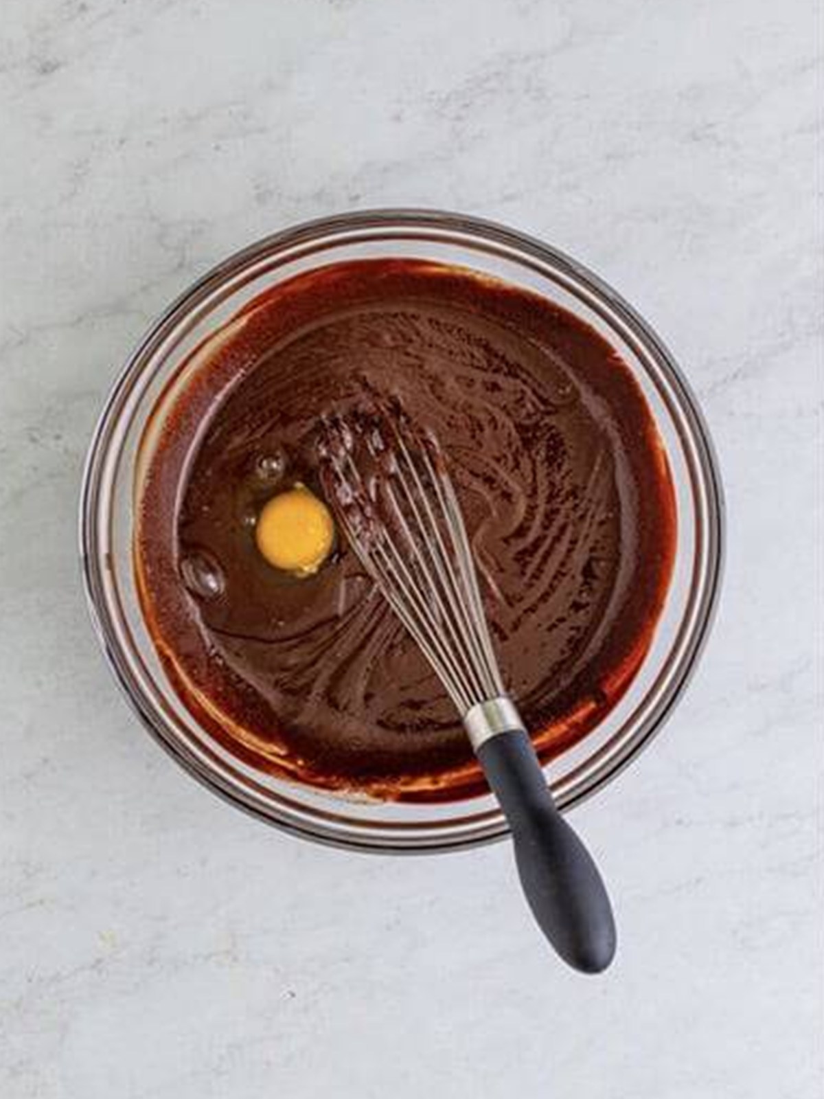 Eggs and cocoa powder added to the melted chocolate mixture to form a batter.