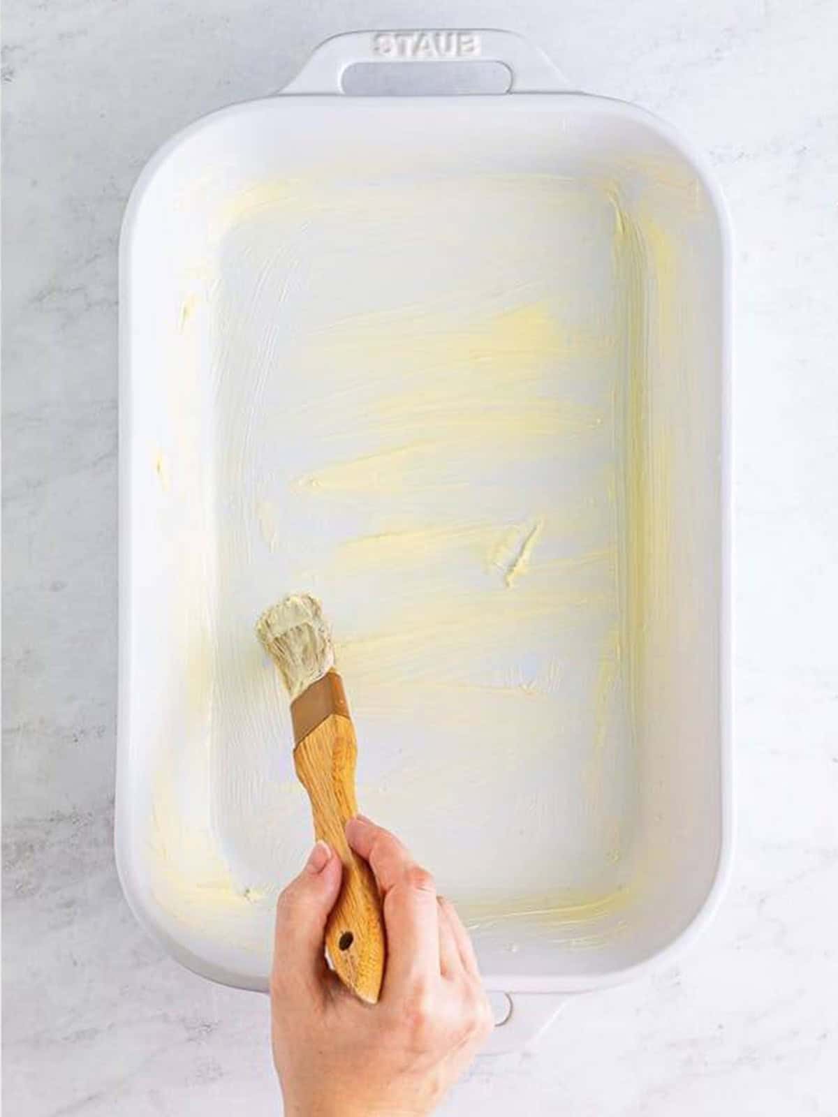 A baking dish brushed with butter before adding the focaccia dough.
