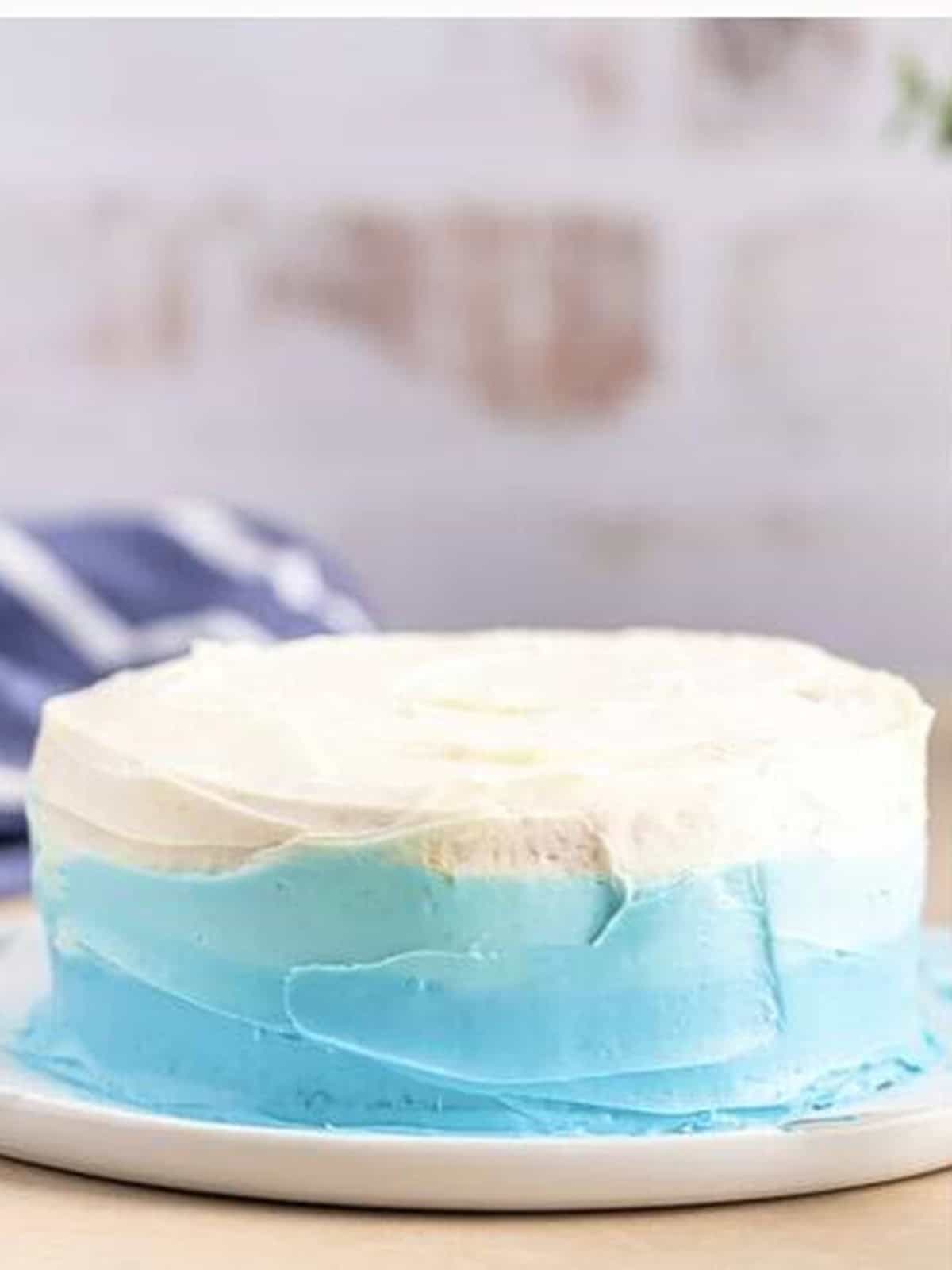 The smoothed ombre smash cake blending blue into white.