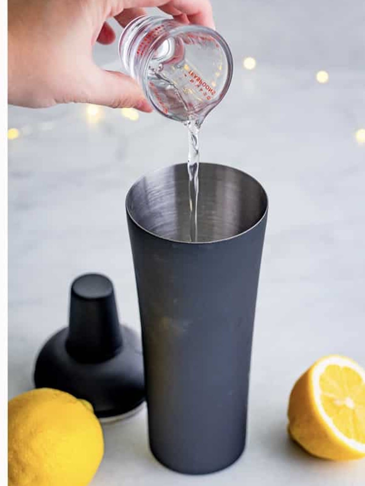 Adding simple syrup before shaking and straining the French 75.