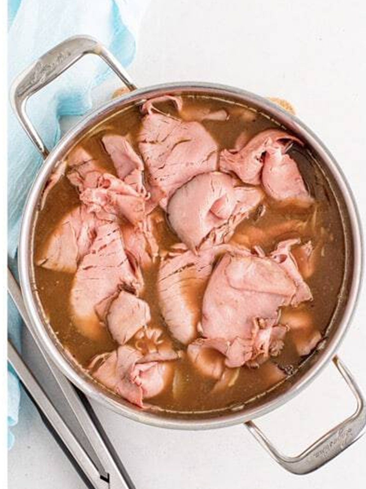 Thinly sliced deli roast beef added to the simmering au jus in the skillet.