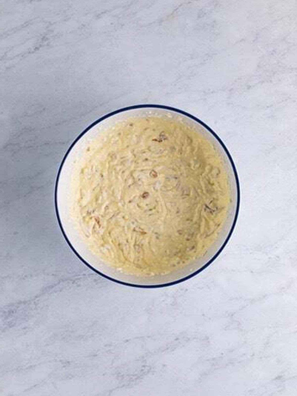 Finished French onion dip stirred together in a bowl.