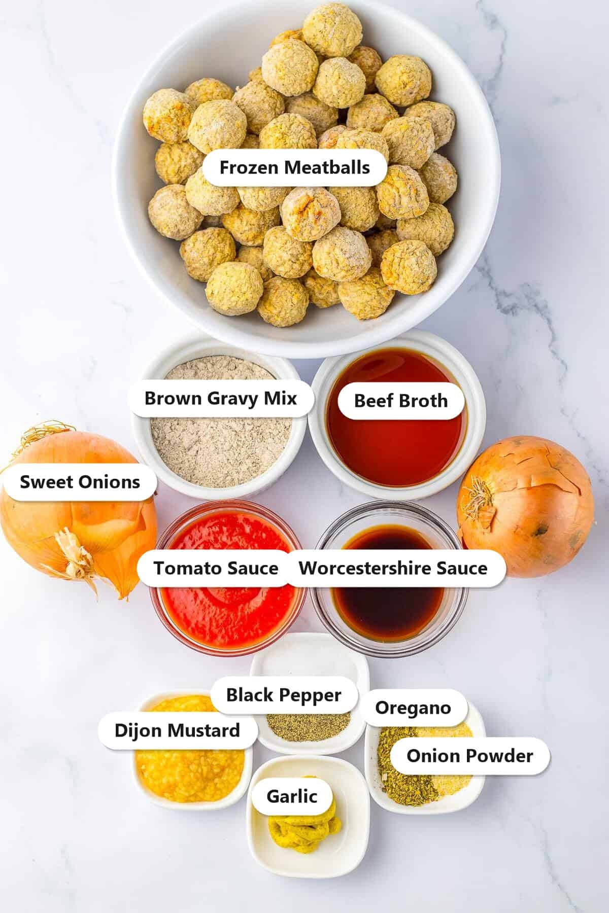 Labeled ingredients for slow cooker French onion meatballs including frozen meatballs, sweet onions, beef broth, brown gravy mix, and seasonings.