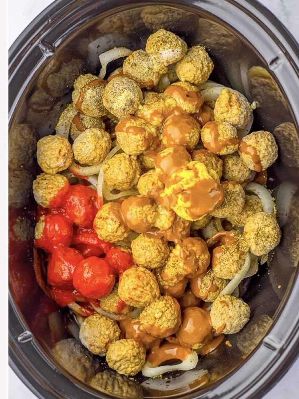 Tomato sauce, Worcestershire, mustard, and gravy added to the meatballs in the slow cooker.