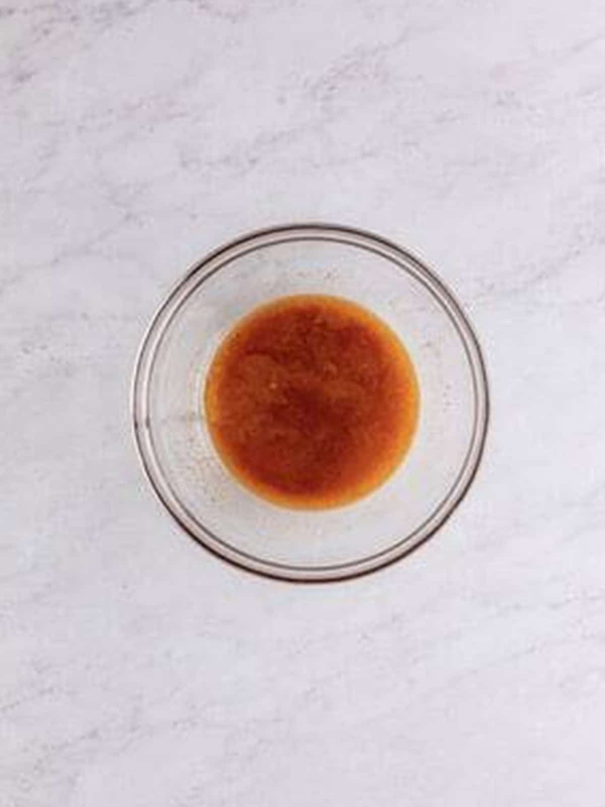 Melted butter and brown sugar topping mixed in a small bowl.