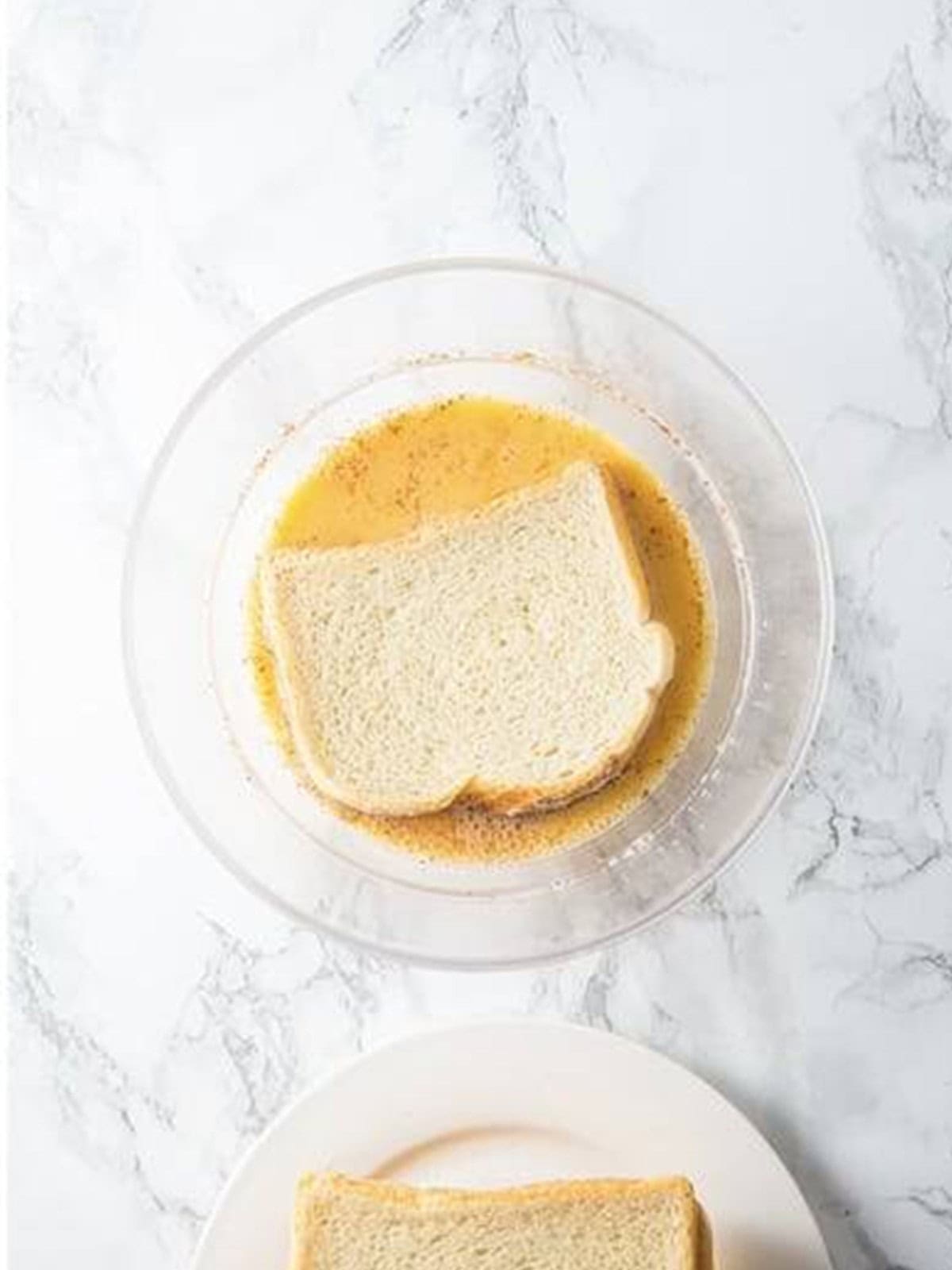 Thick-cut slices of bread ready to be dipped for French toast.