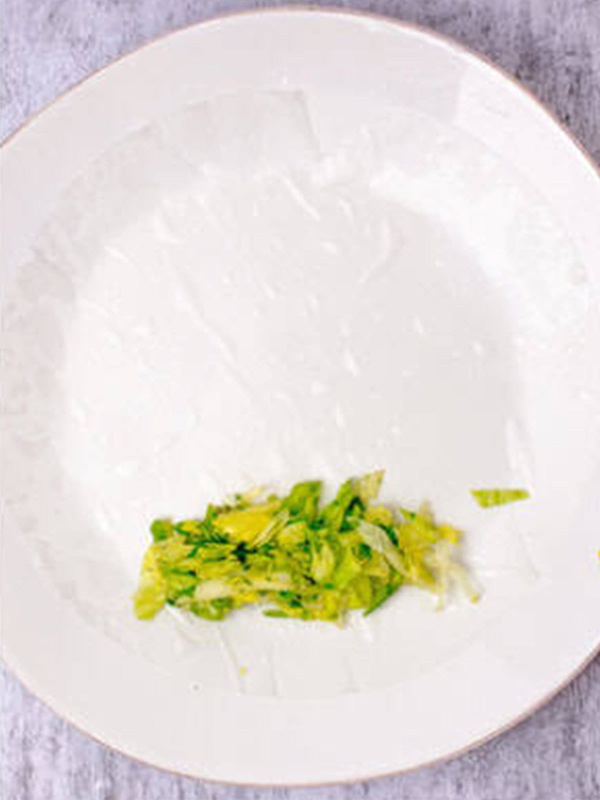 Lettuce mixture placed on a softened rice paper wrapper to make fresh spring rolls.