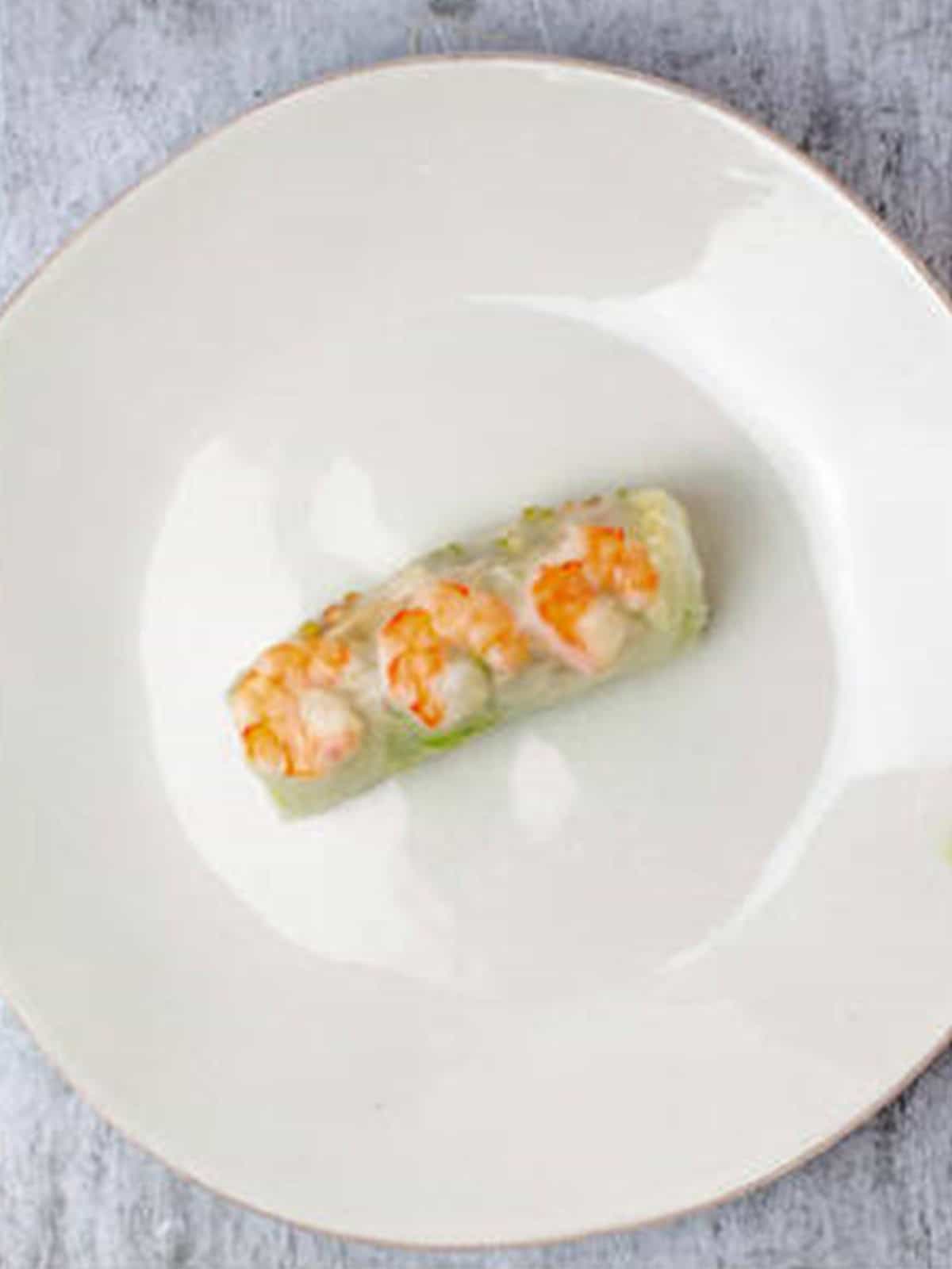 Finished fresh spring roll rolled up tightly and sealed.