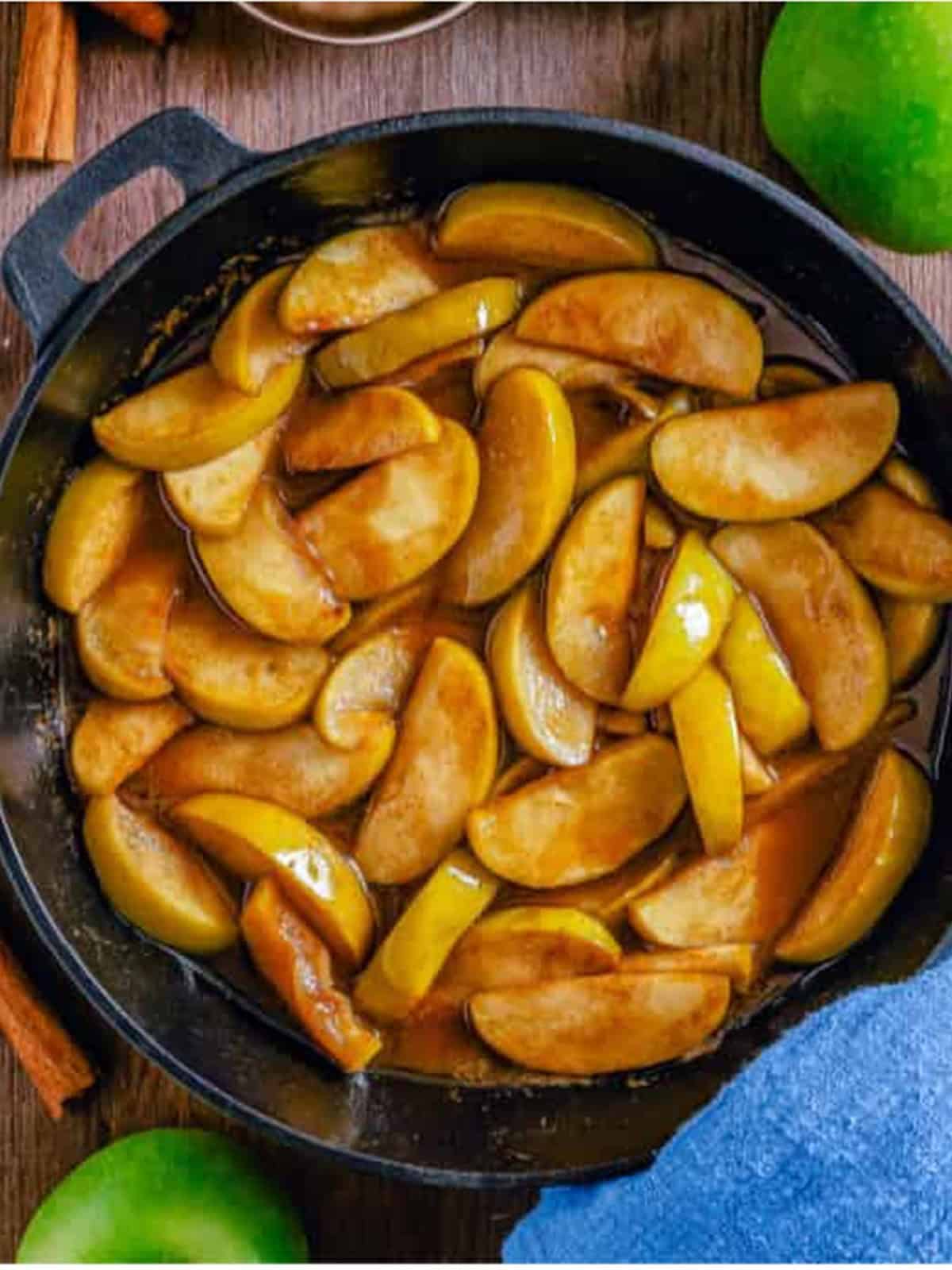 Finished fried apples cooked until fork tender in a cast iron skillet.