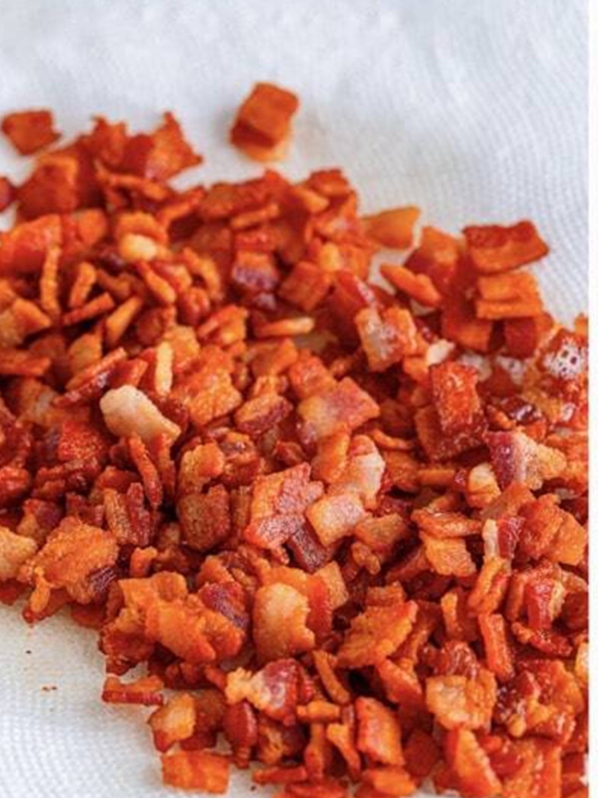 Diced bacon cooked until crispy in a dutch oven for fried cabbage.