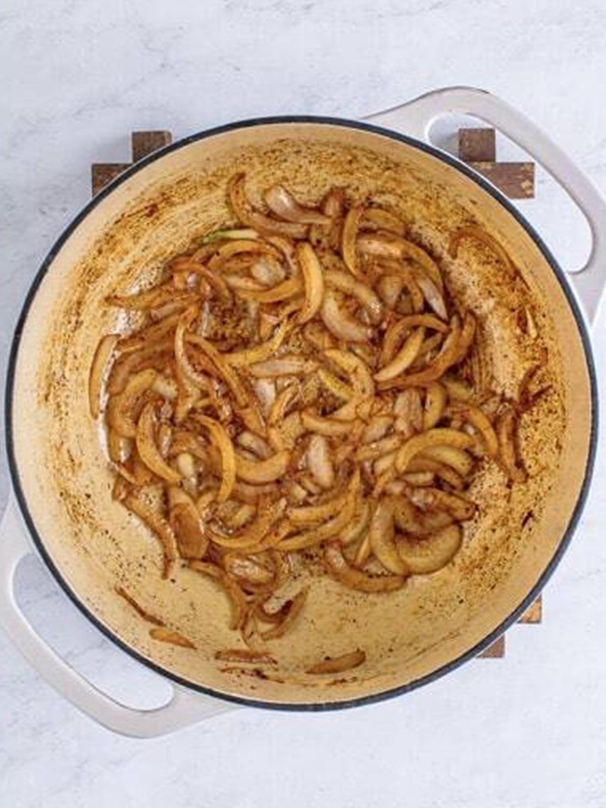 Sliced onions sauteing in bacon fat for southern fried cabbage.