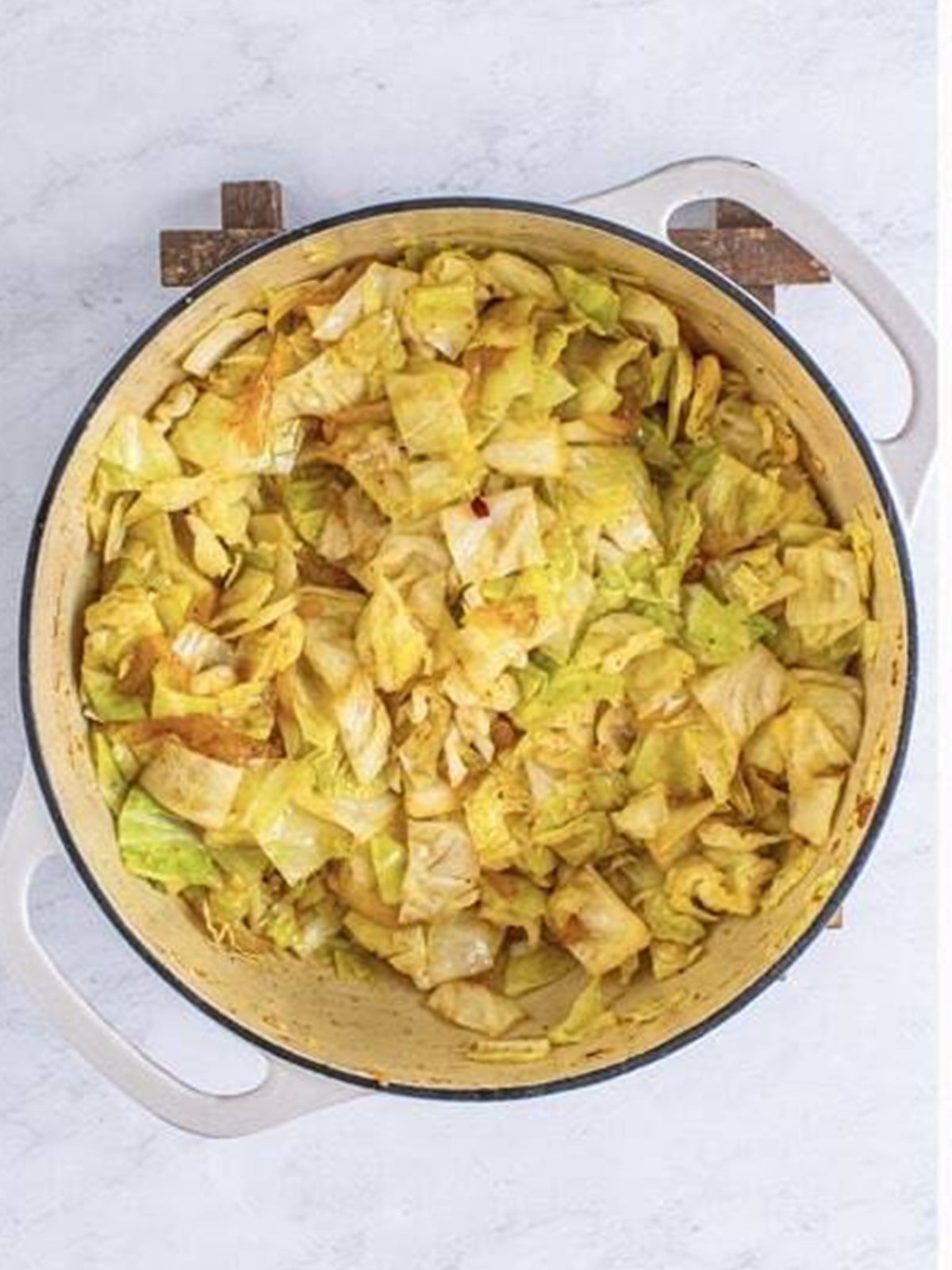 Cabbage cooking down with apple cider vinegar and seasonings.