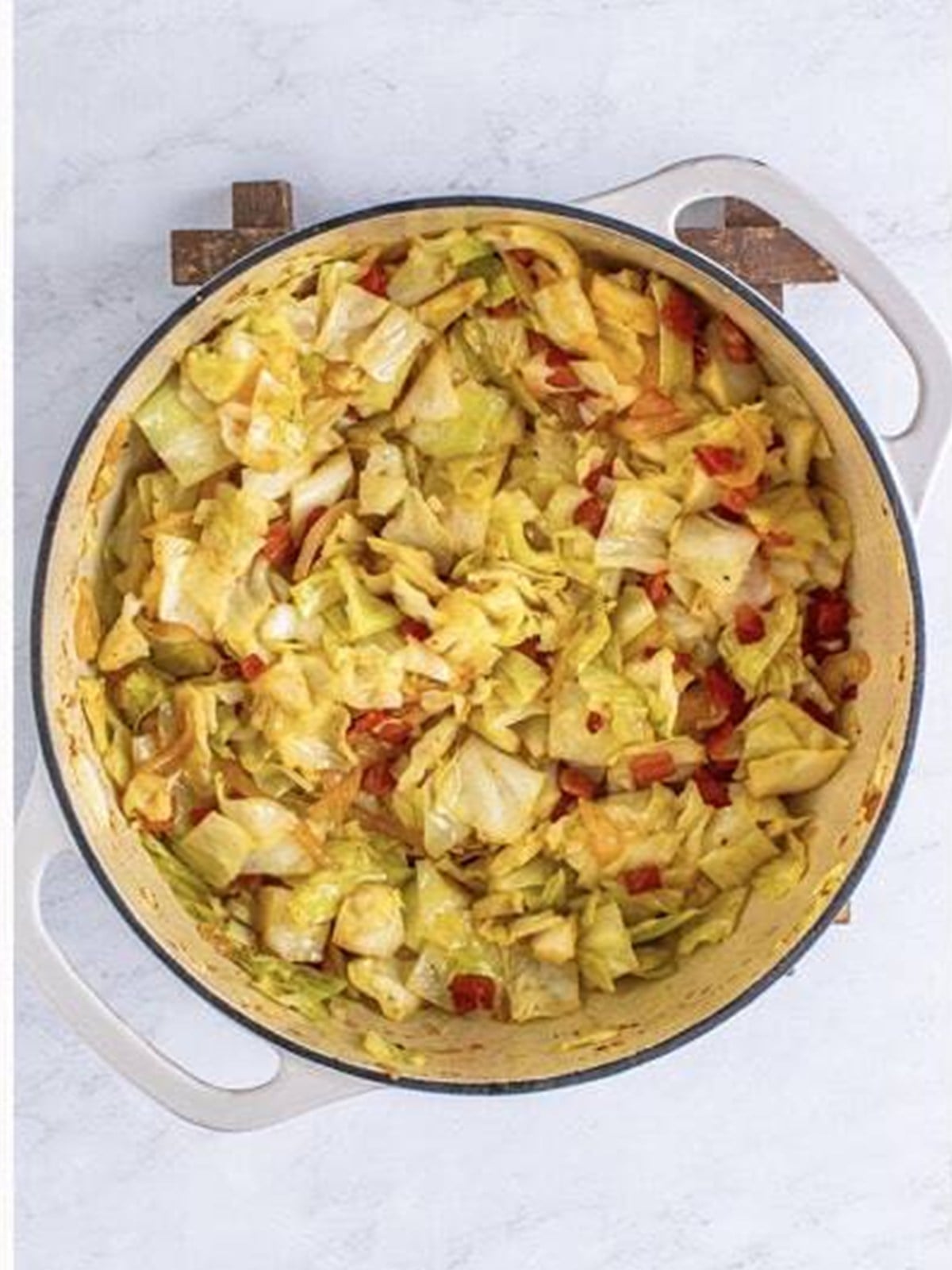 Finished southern fried cabbage with bacon in a pot.