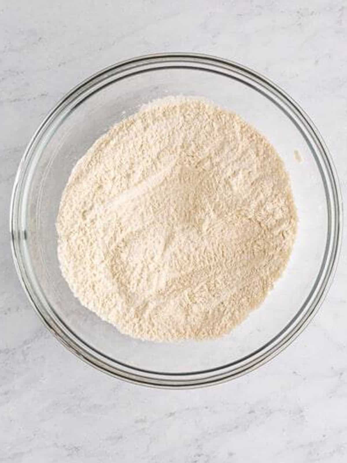 Flour, baking powder, sugar, and salt whisked together for fried green bean batter.