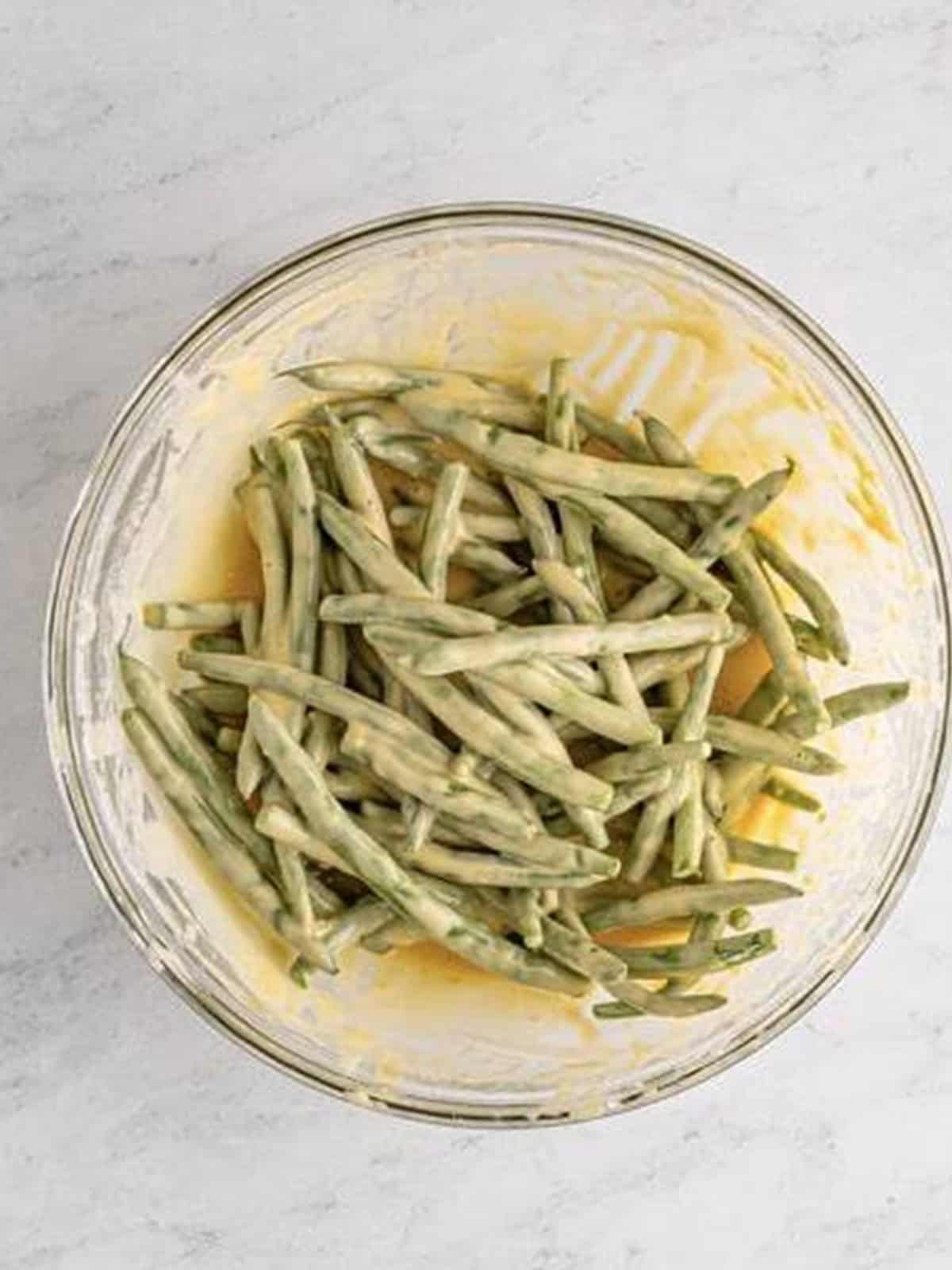 Green beans coated in beer batter for frying.