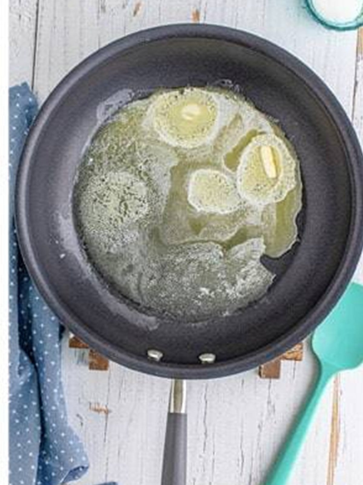 Butter melting in a skillet to toast the cornflake coating for fried ice cream.