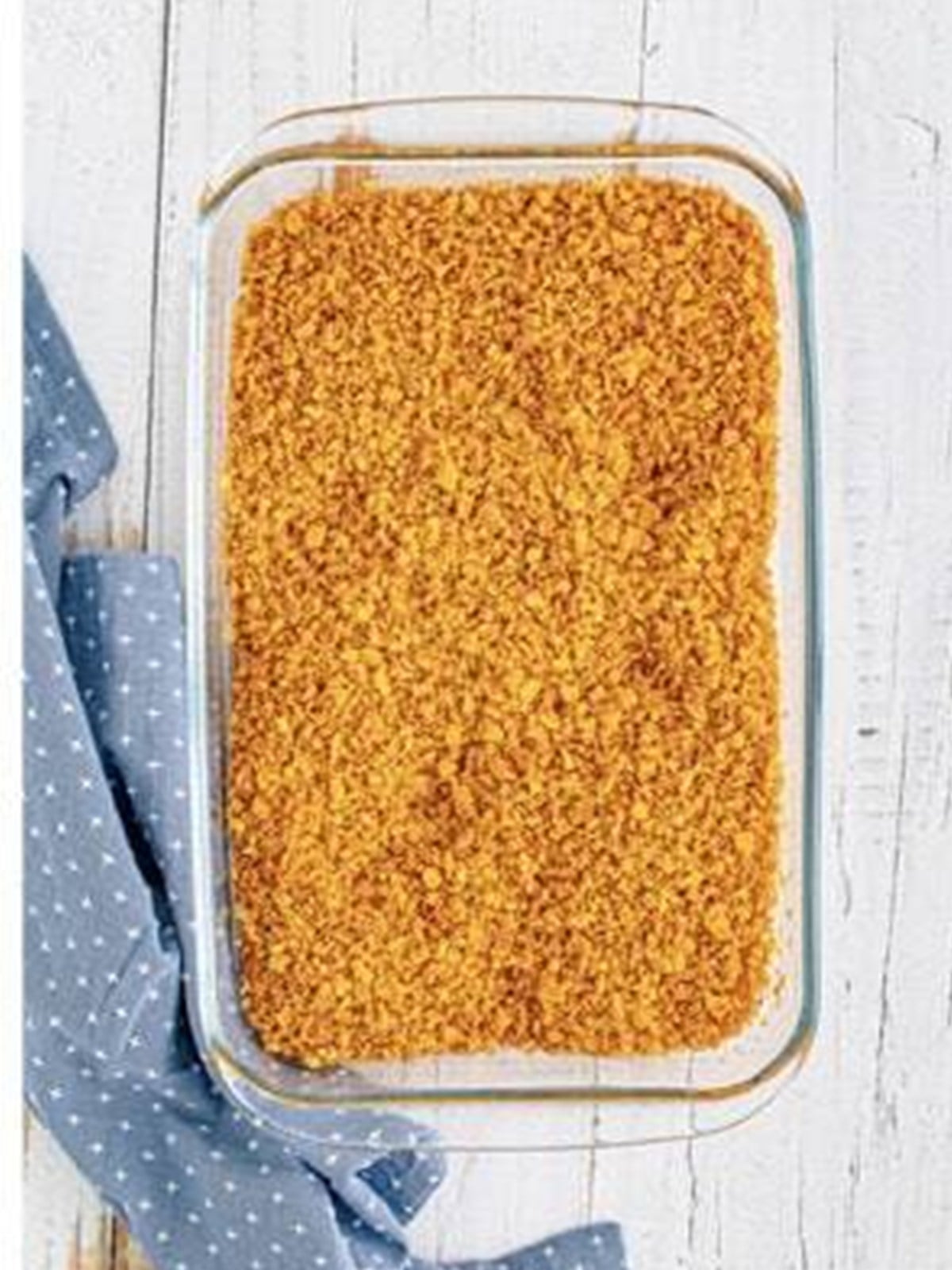 Toasted cornflake crumbs spread in a dish to cool for fried ice cream.