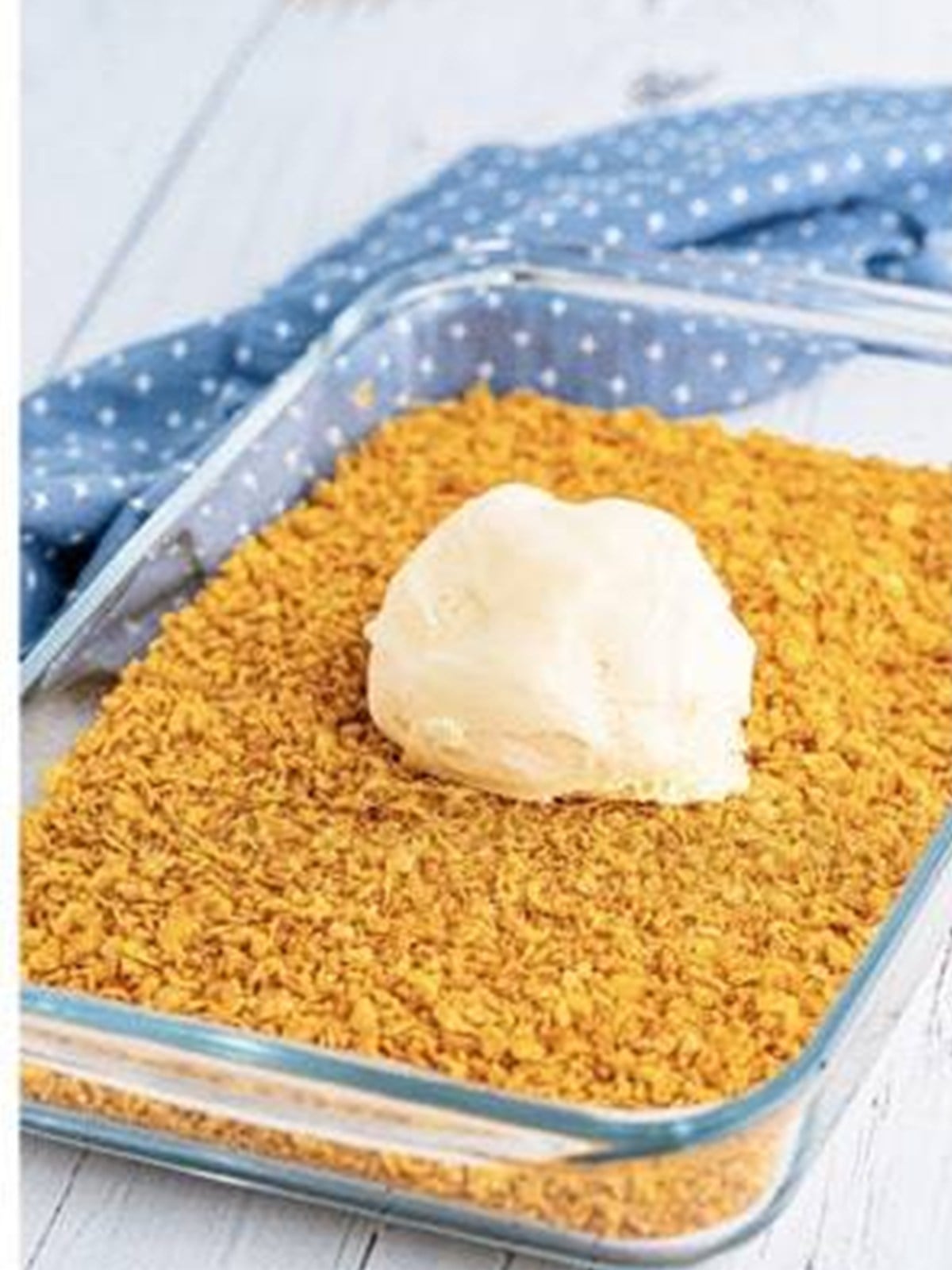 Rolling a frozen ice cream ball in the cooled cornflake crumbs.