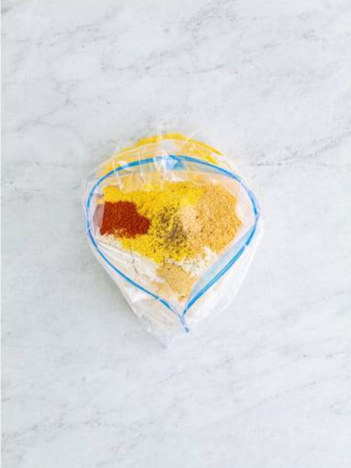 Flour, cornmeal, and spices combined in a zip-top bag for fried okra breading.