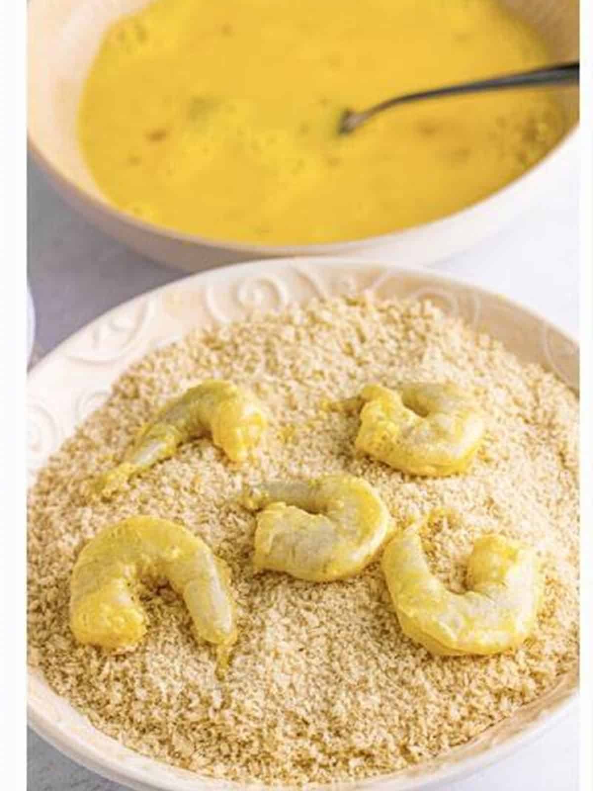 Coating shrimp in panko breadcrumbs for fried shrimp recipe.