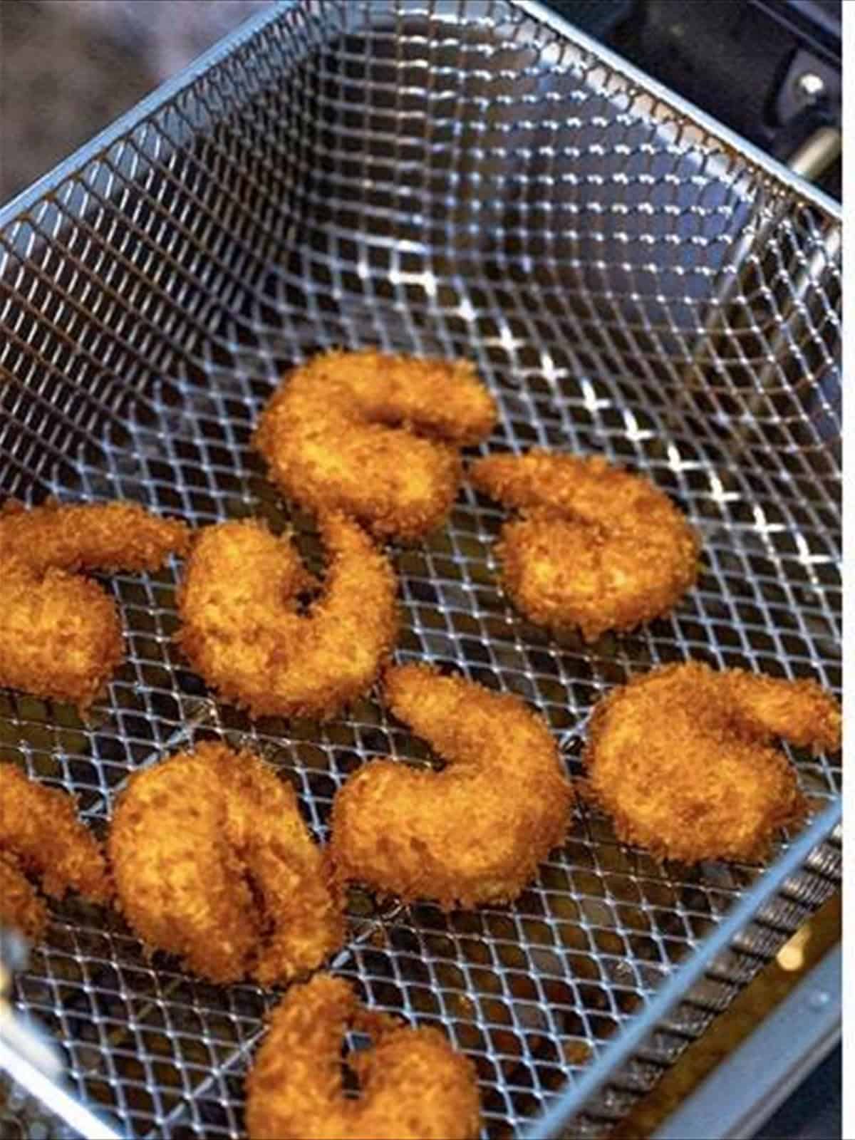Frying breaded shrimp until golden for fried shrimp recipe.