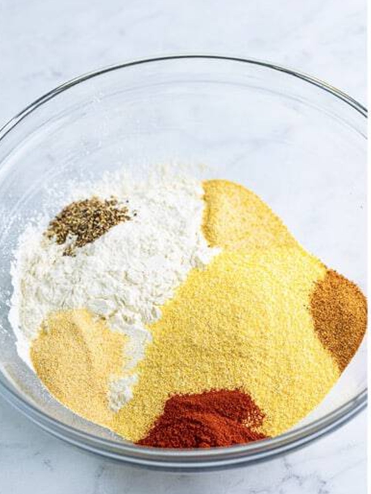 Stirring together flour, cornmeal, and creole seasoning for the Fried Shrimp coating.