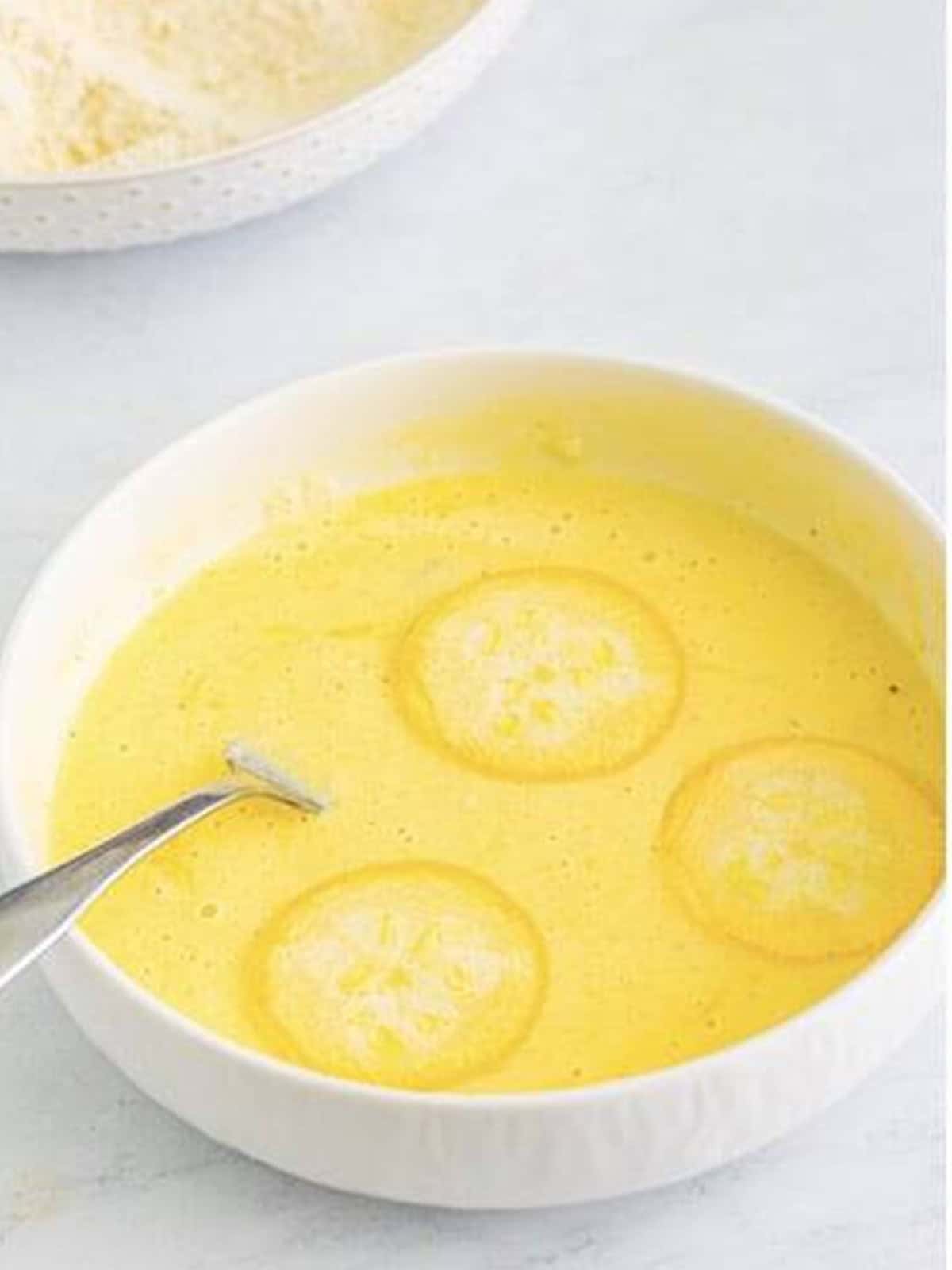 Squash rounds dipped into the buttermilk and egg mixture.