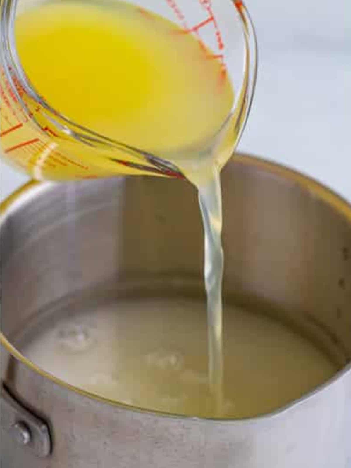 Fresh lemon juice added to the saucepan for frosted lemonade.