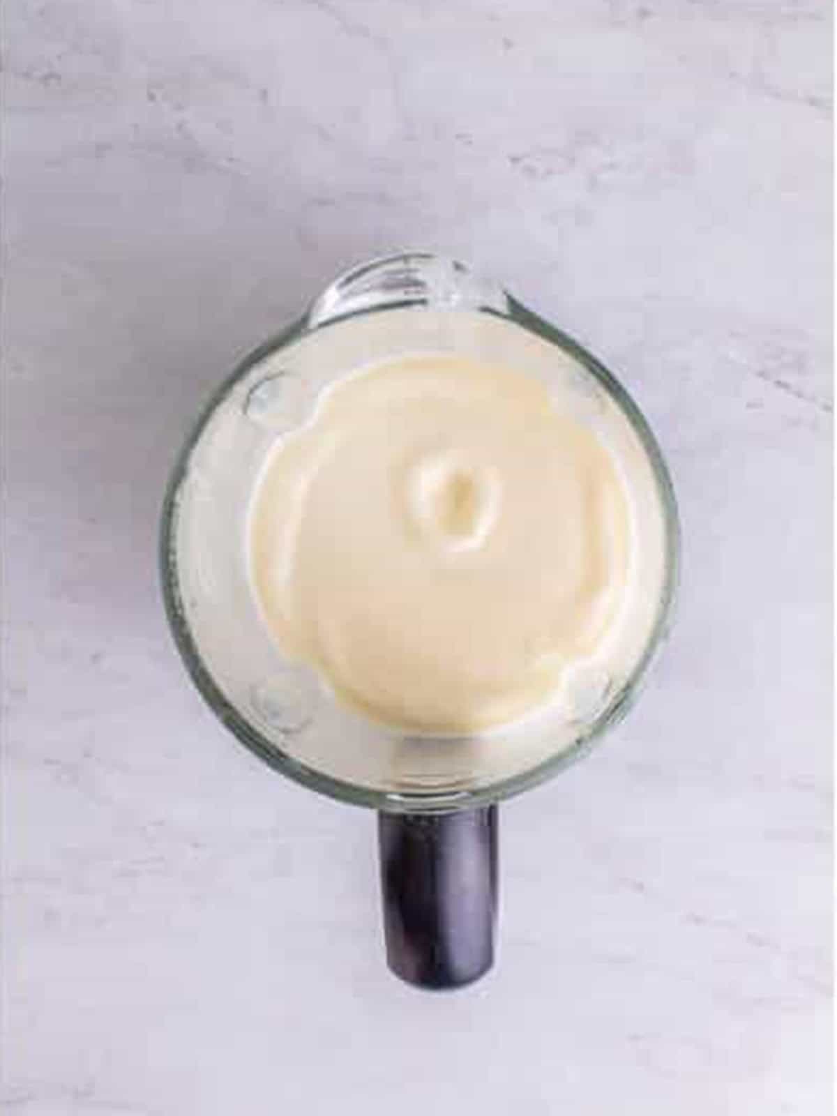Blended creamy frosted lemonade in a blender.