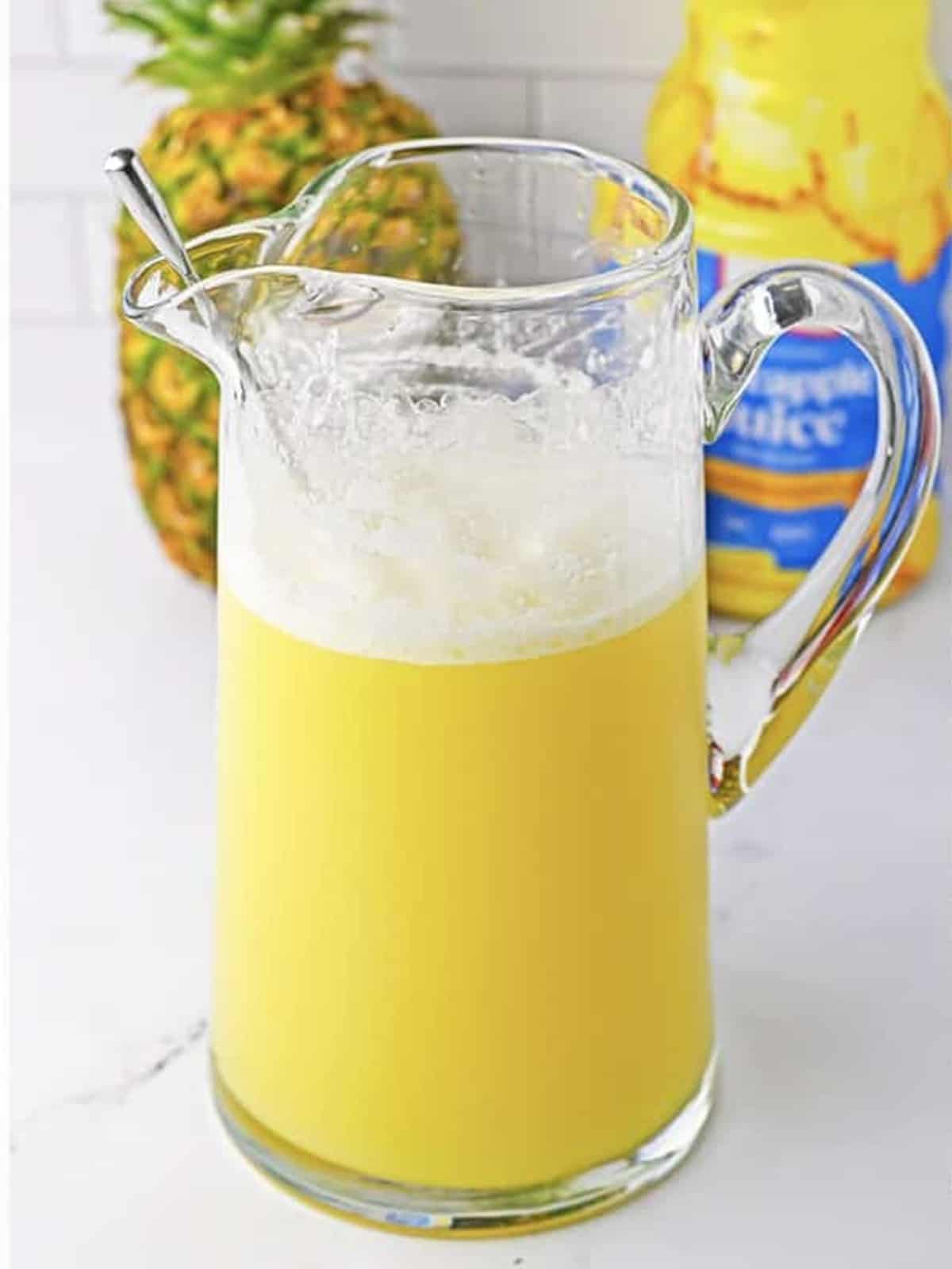 Pitcher of finished tropical fruit punch recipe ready to serve over ice.