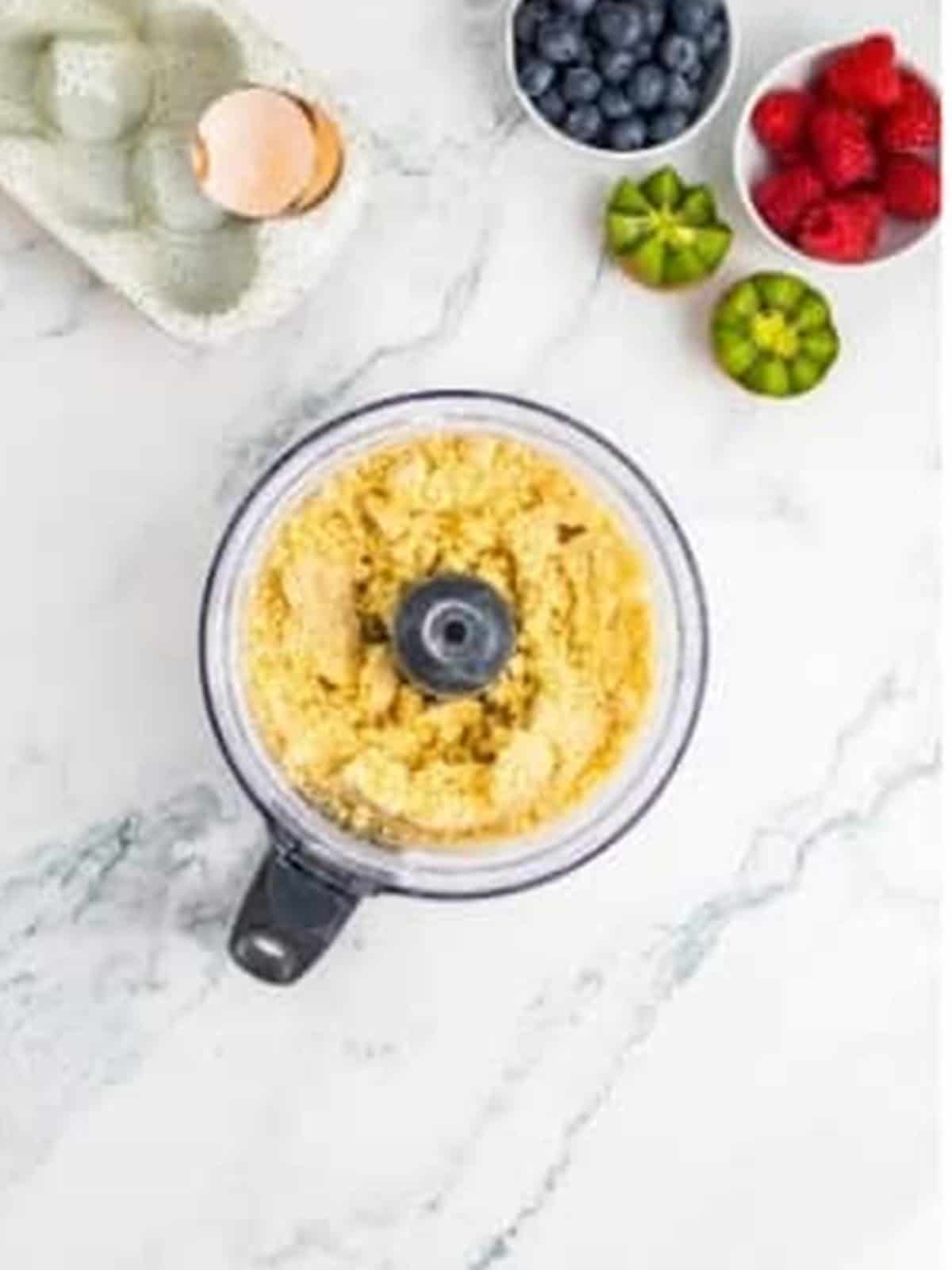 Shortcrust tartlet dough coming together in a food processor.