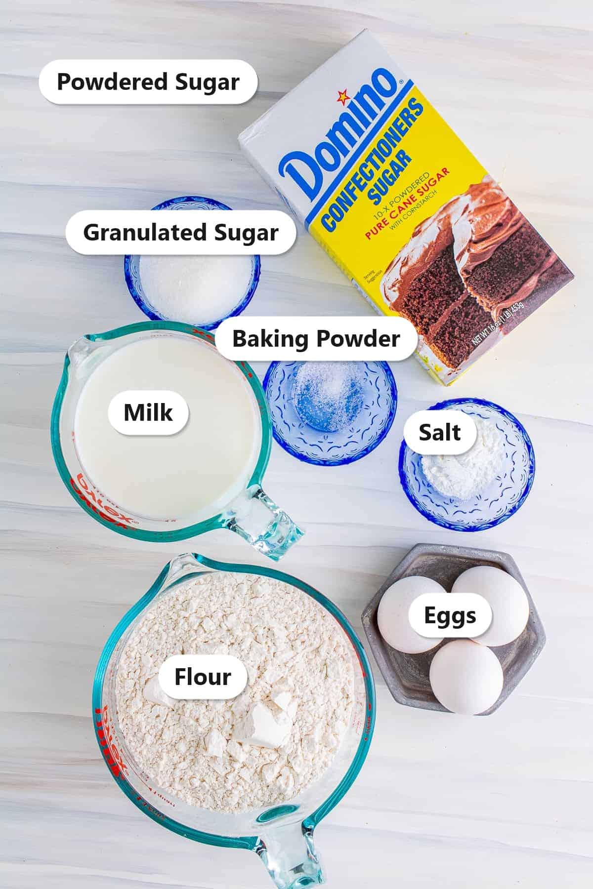 Labeled funnel cake recipe ingredients including flour, milk, eggs, sugar, baking powder, and powdered sugar.