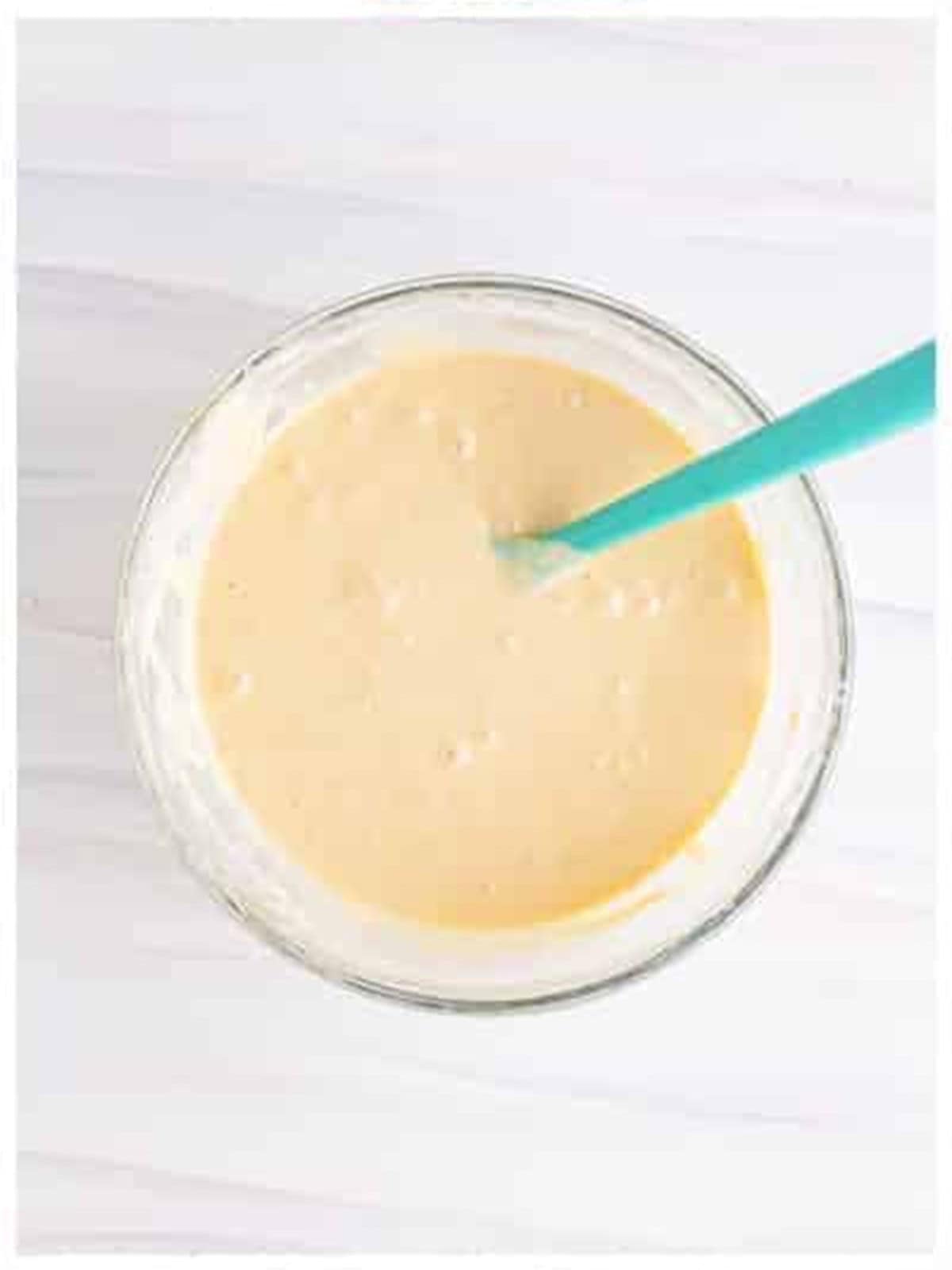 Smooth funnel cake recipe batter in a bowl.