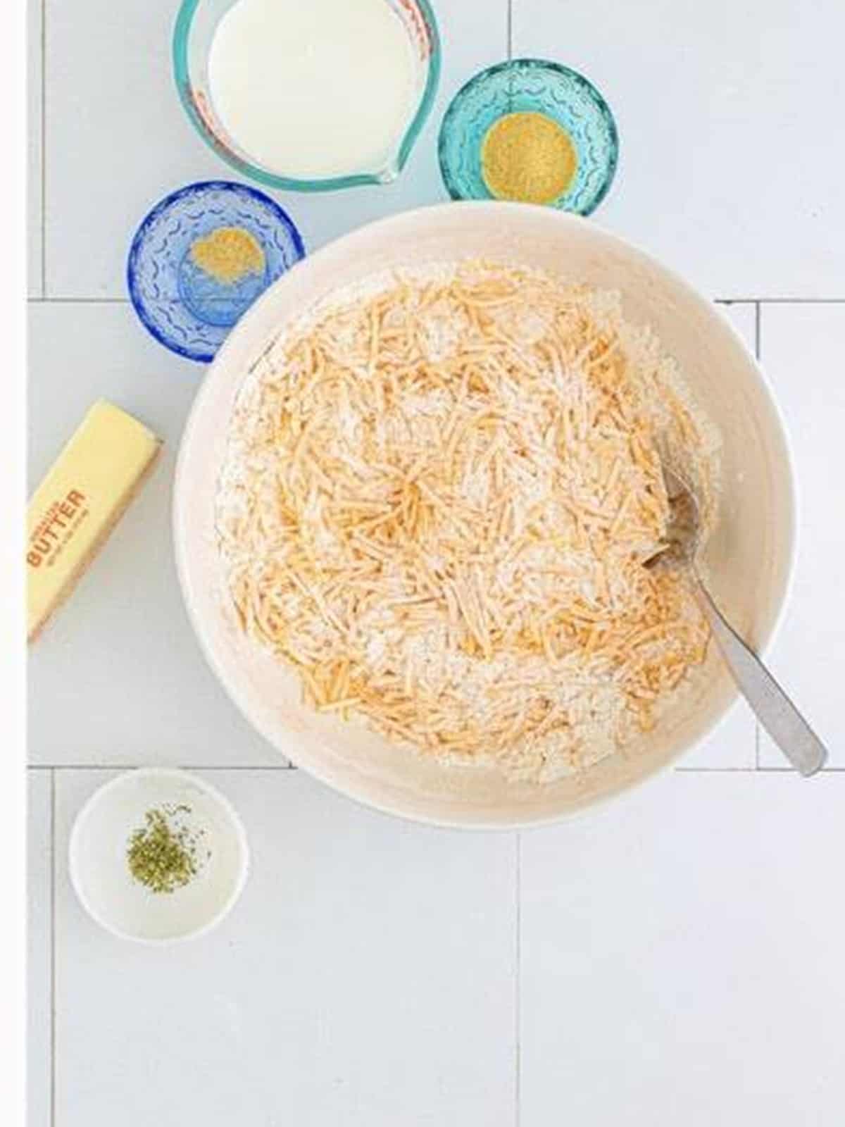 Shredded cheddar cheese stirred into the flour mixture.