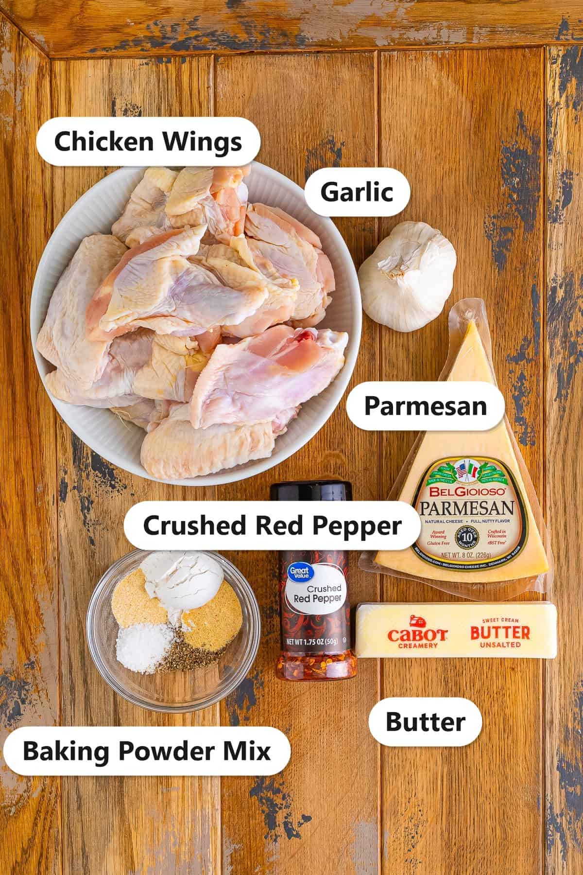Labeled ingredients for Garlic Parmesan Wings including chicken wings, baking powder mix, garlic, parmesan, crushed red pepper, and butter.