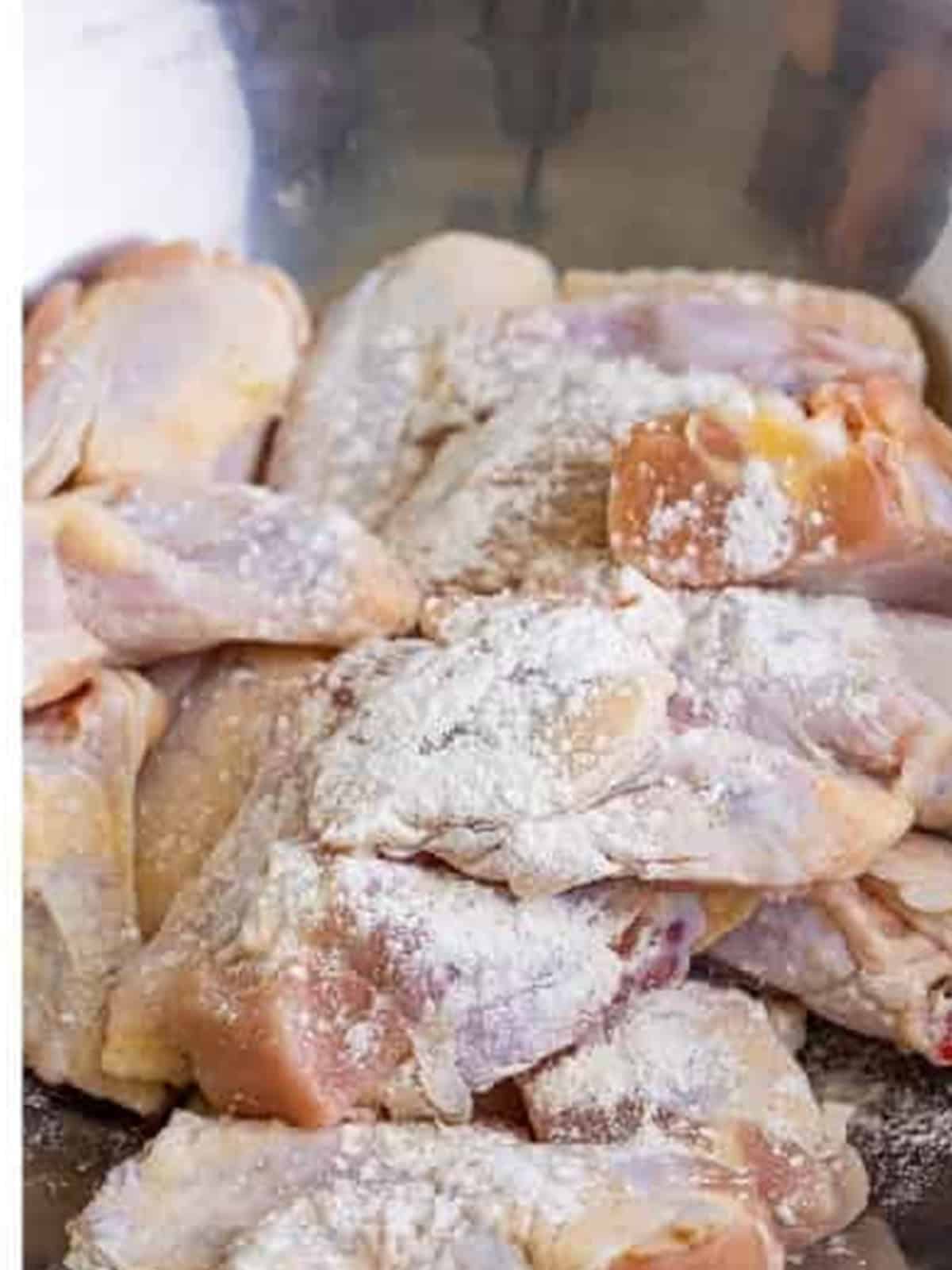 Tossing chicken wings in the baking powder seasoning mixture for Garlic Parmesan Wings.