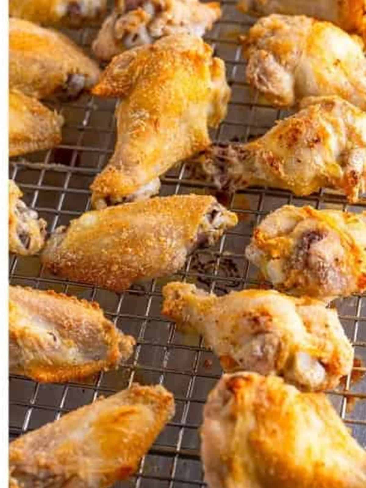 Crispy baked chicken wings on a wire rack for Garlic Parmesan Wings.