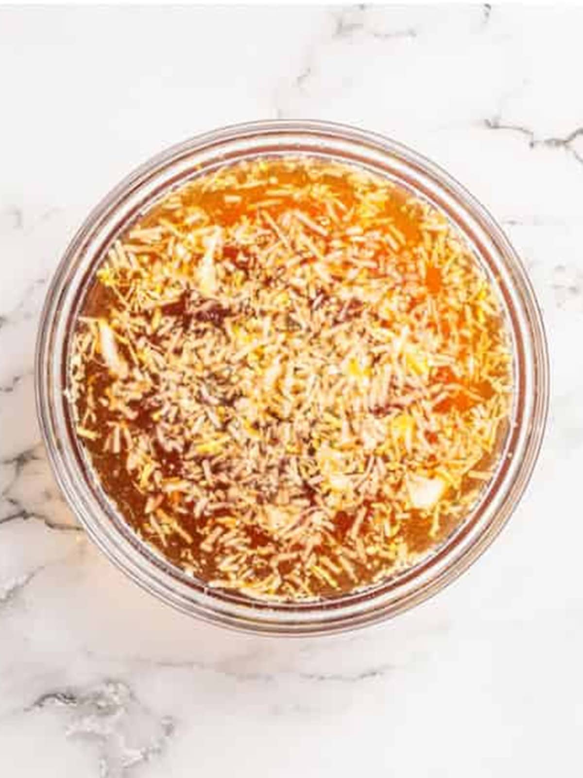Ginger chicken sauce whisked together in a glass bowl.