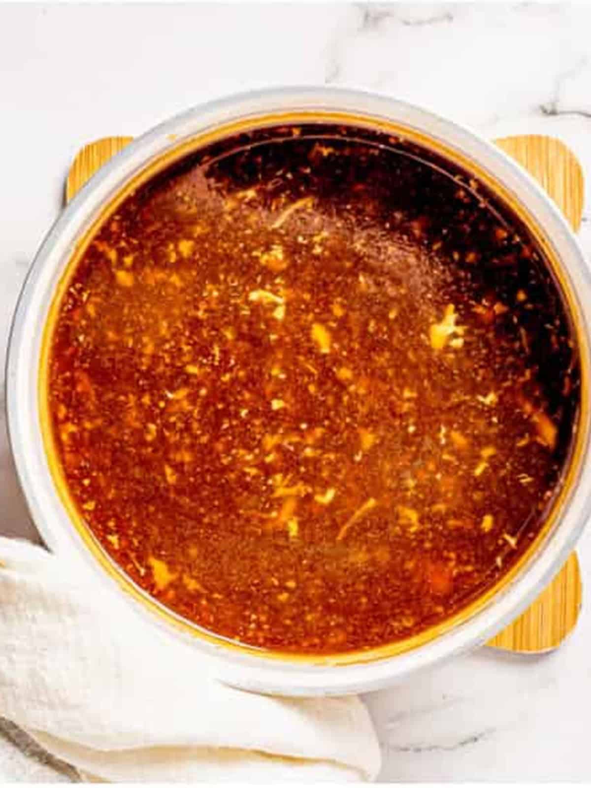 Thickened ginger chicken sauce in a saucepan.