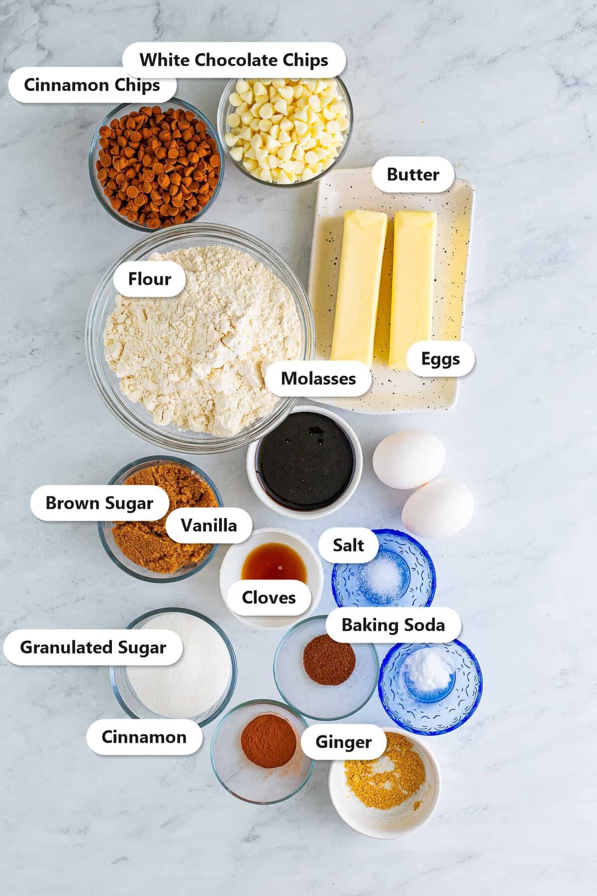 Labeled ingredients for soft gingerbread cookies including flour, molasses, butter, brown sugar, spices, cinnamon chips, and white chocolate chips.