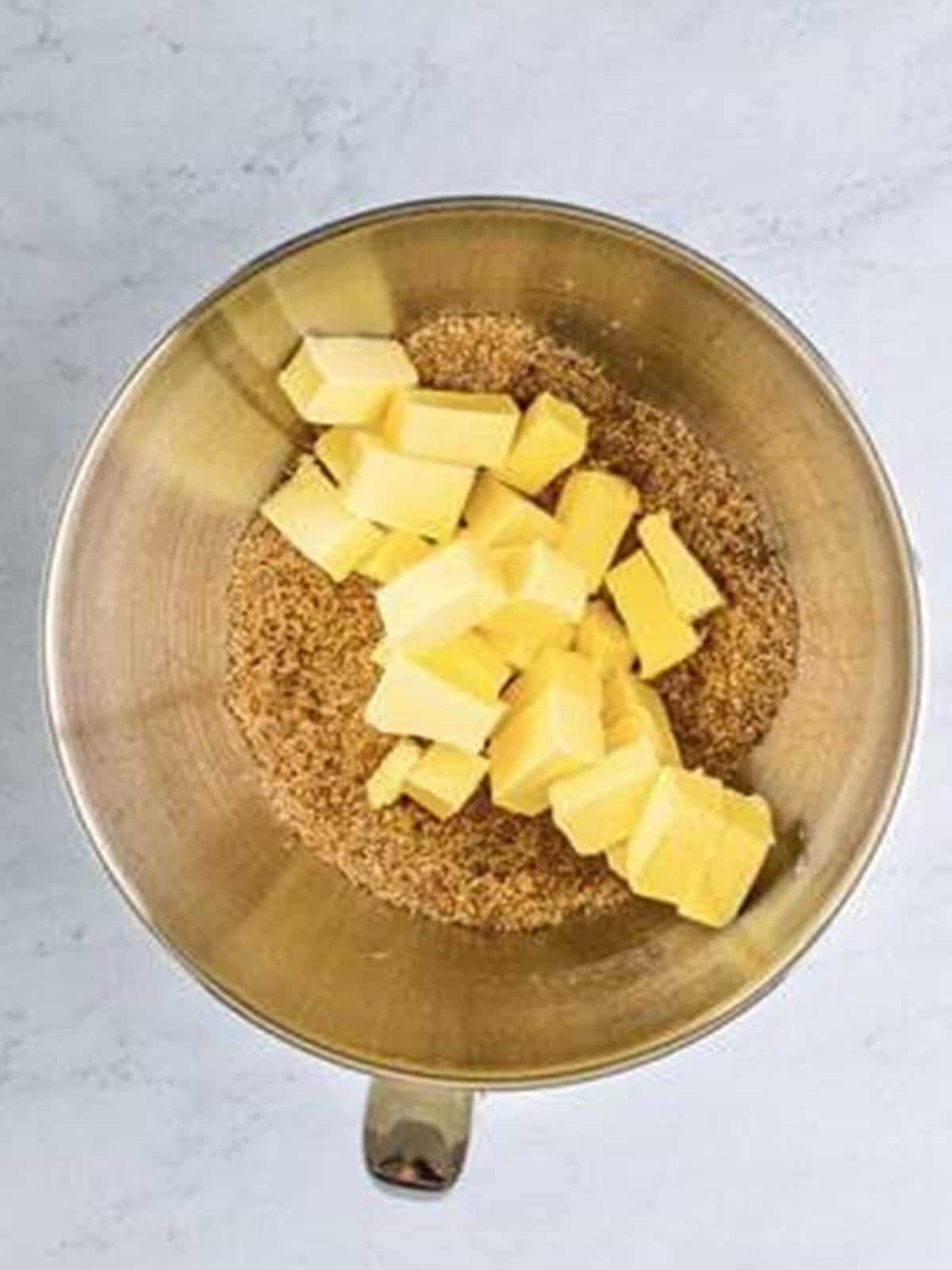 Brown sugar, granulated sugar, and cubed cold butter in a mixer bowl.