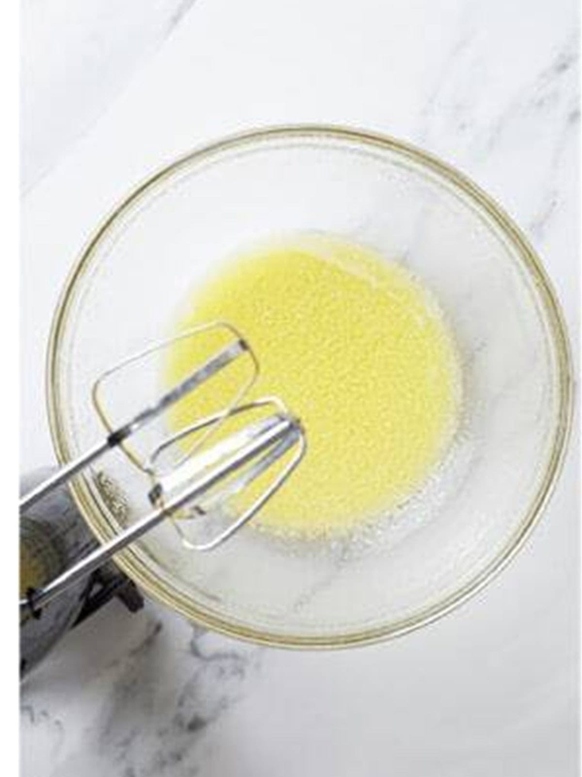 Beating softened butter until smooth and creamy with a hand mixer.