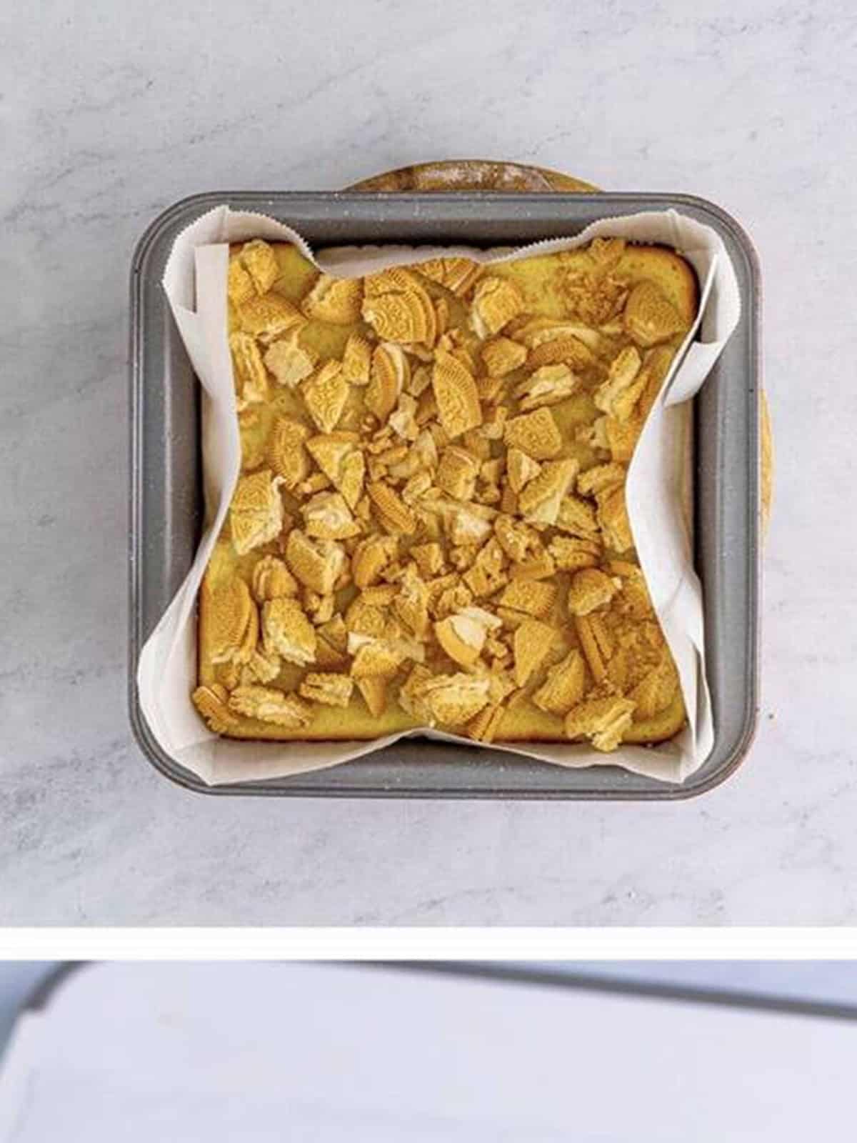 Chopped Golden Oreos pressed into the top of the baked cheesecake bars.