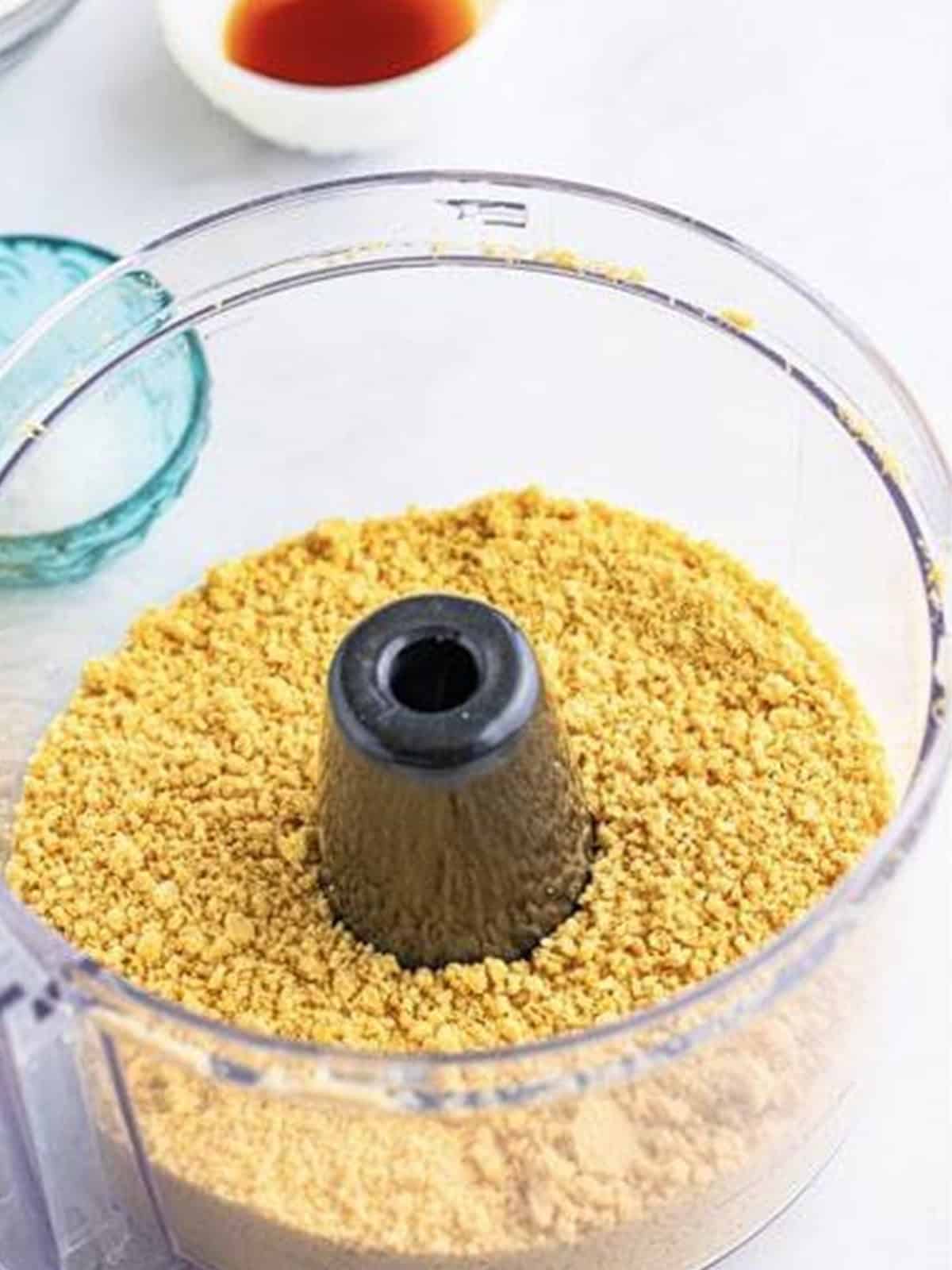 Golden Oreos crushed into fine crumbs in a food processor for golden Oreo cookies.