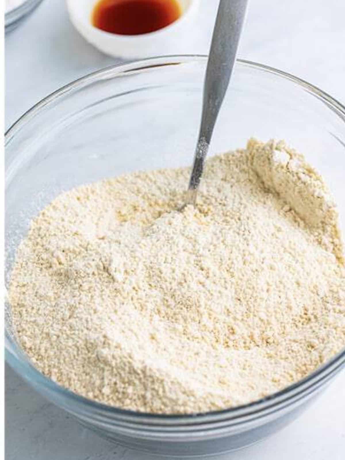 Golden Oreo crumbs, flour, baking powder, and salt stirred together in a bowl.