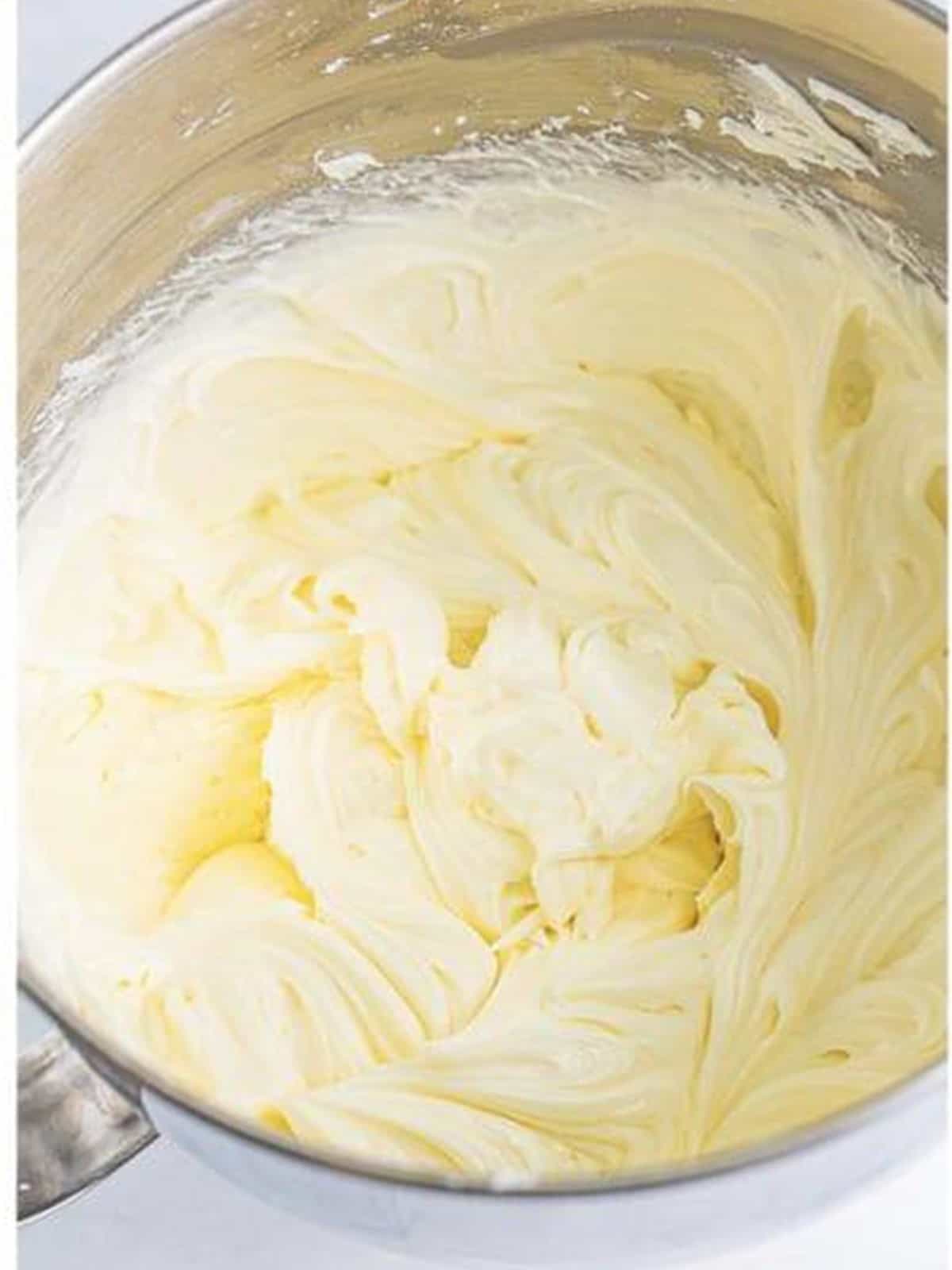 Cream cheese frosting whipped smooth in a stand mixer.