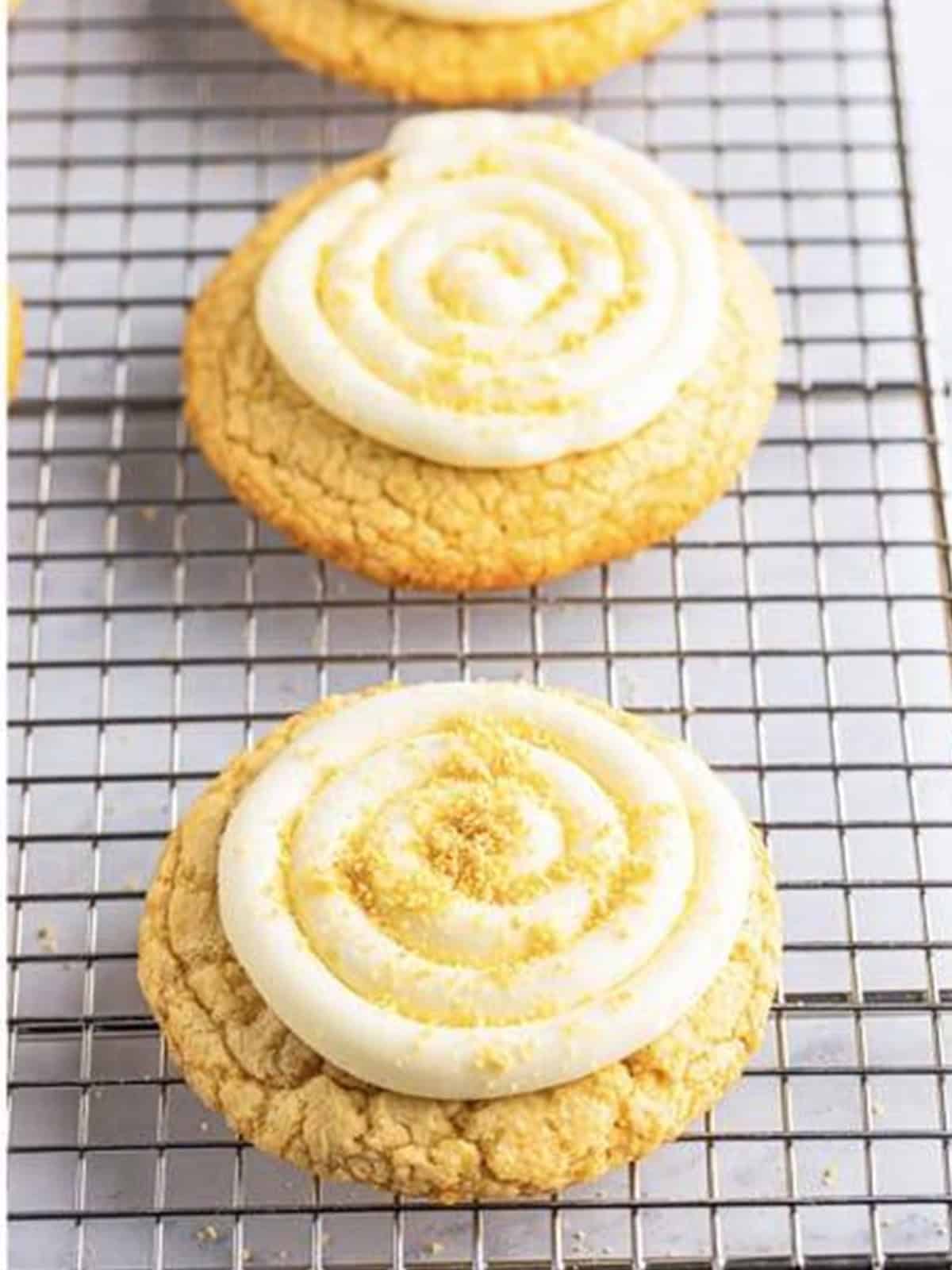 Golden Oreo cookies topped with a swirl of cream cheese frosting and Oreo crumbs.